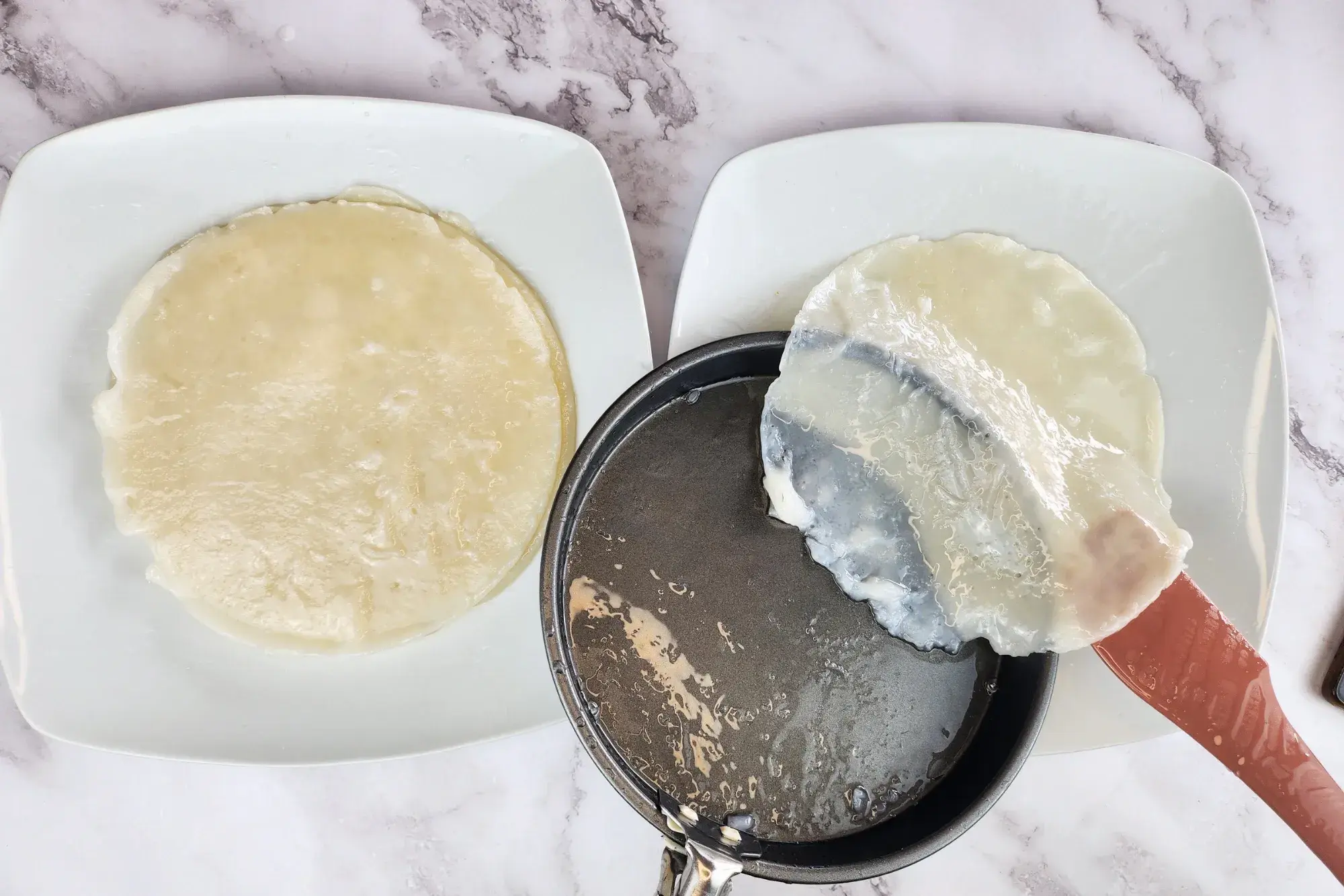 use a spatula to gently lift and peel the noodle sheet from the tray