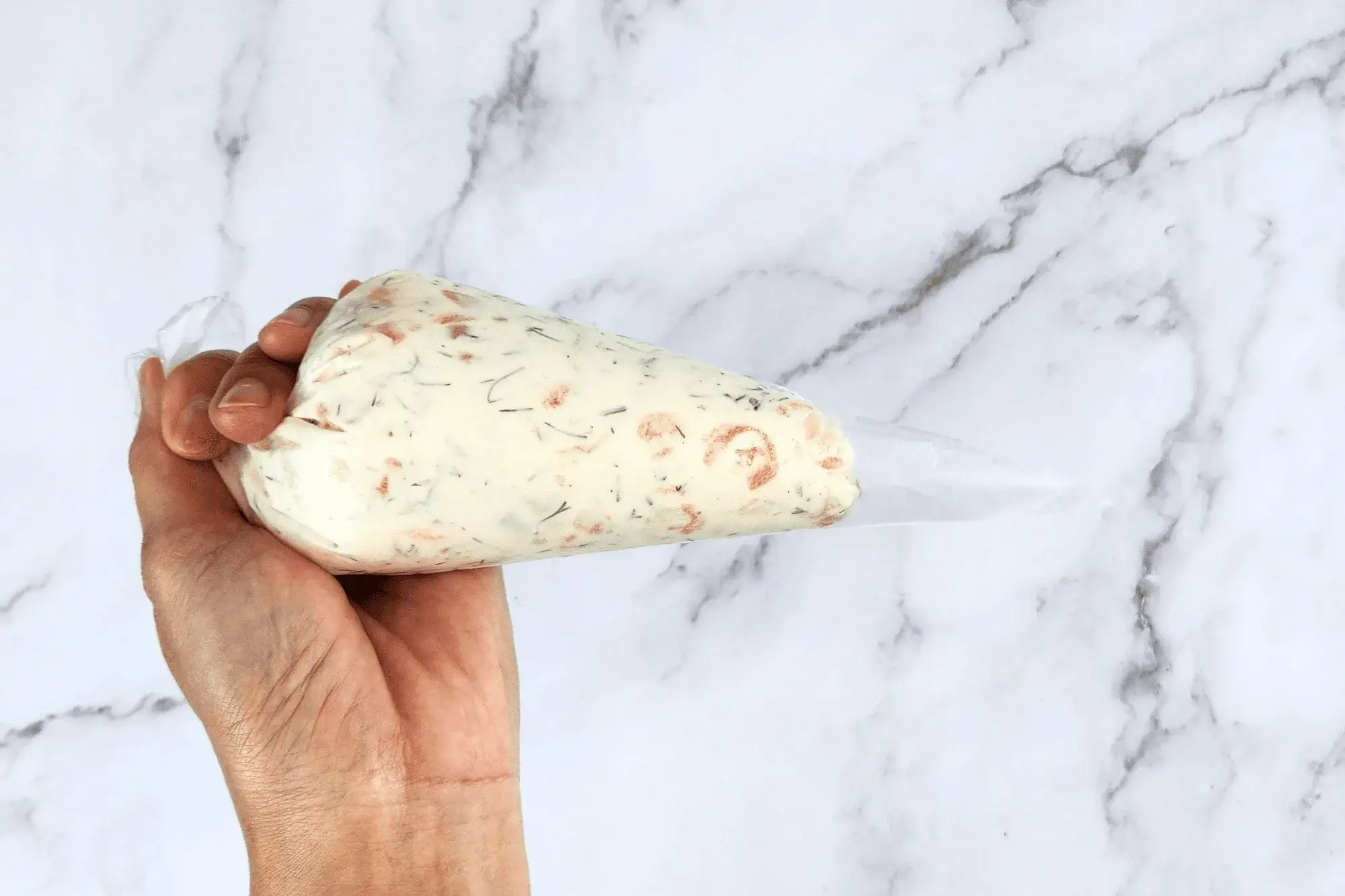 using a piping bag for a clean, easy fill.