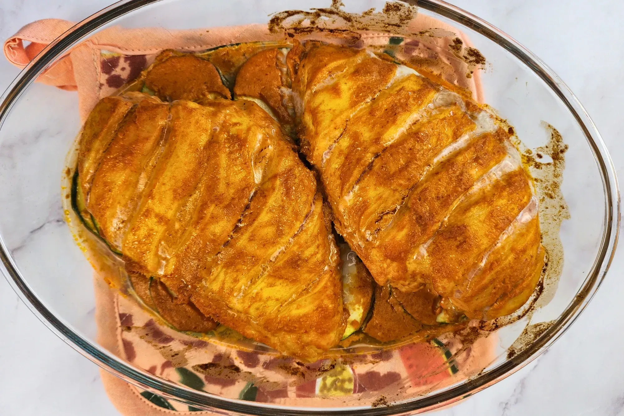 A baking bowl of cooked chicken breasts