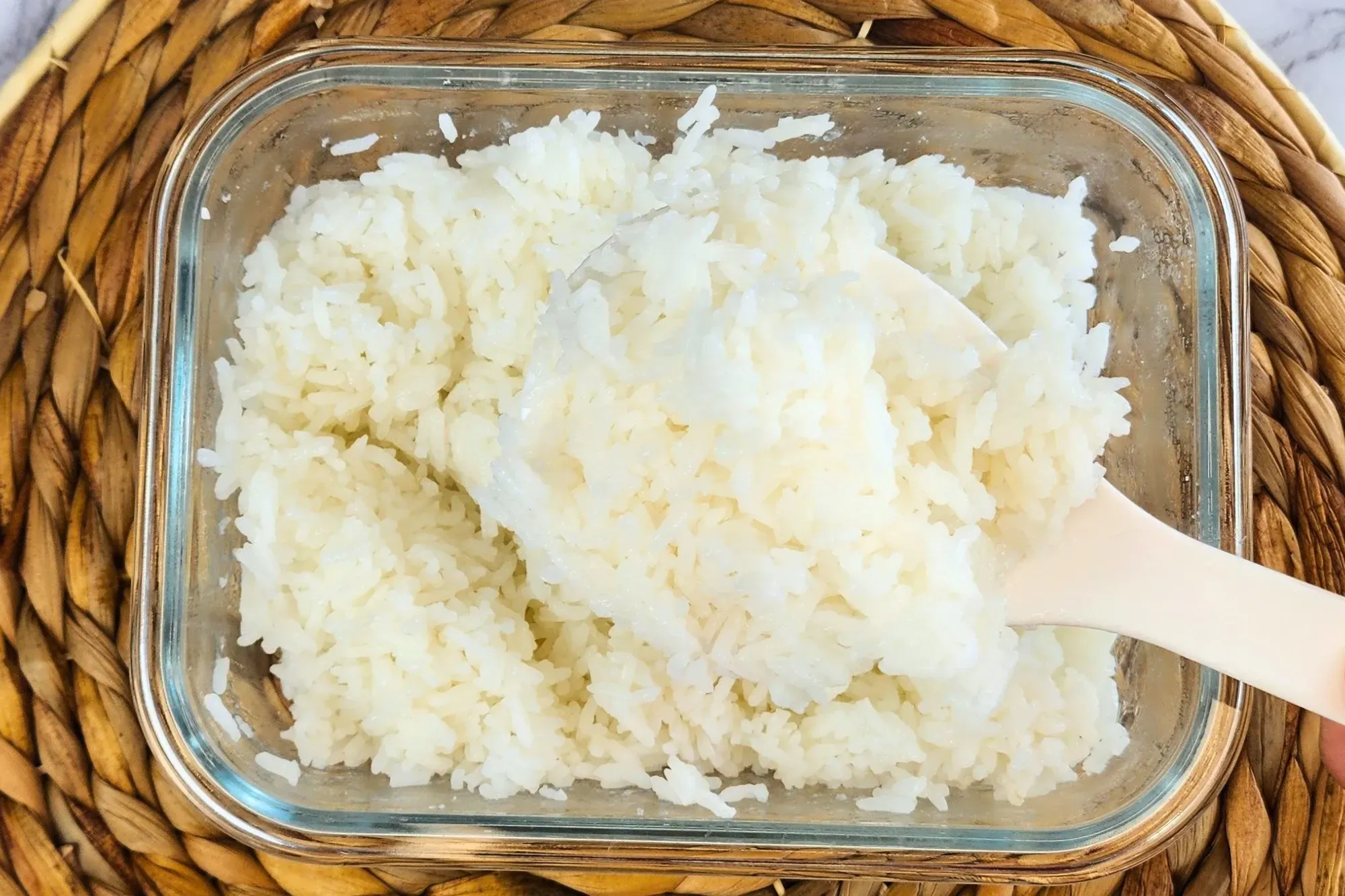 A big spoon is in jasmine rice container