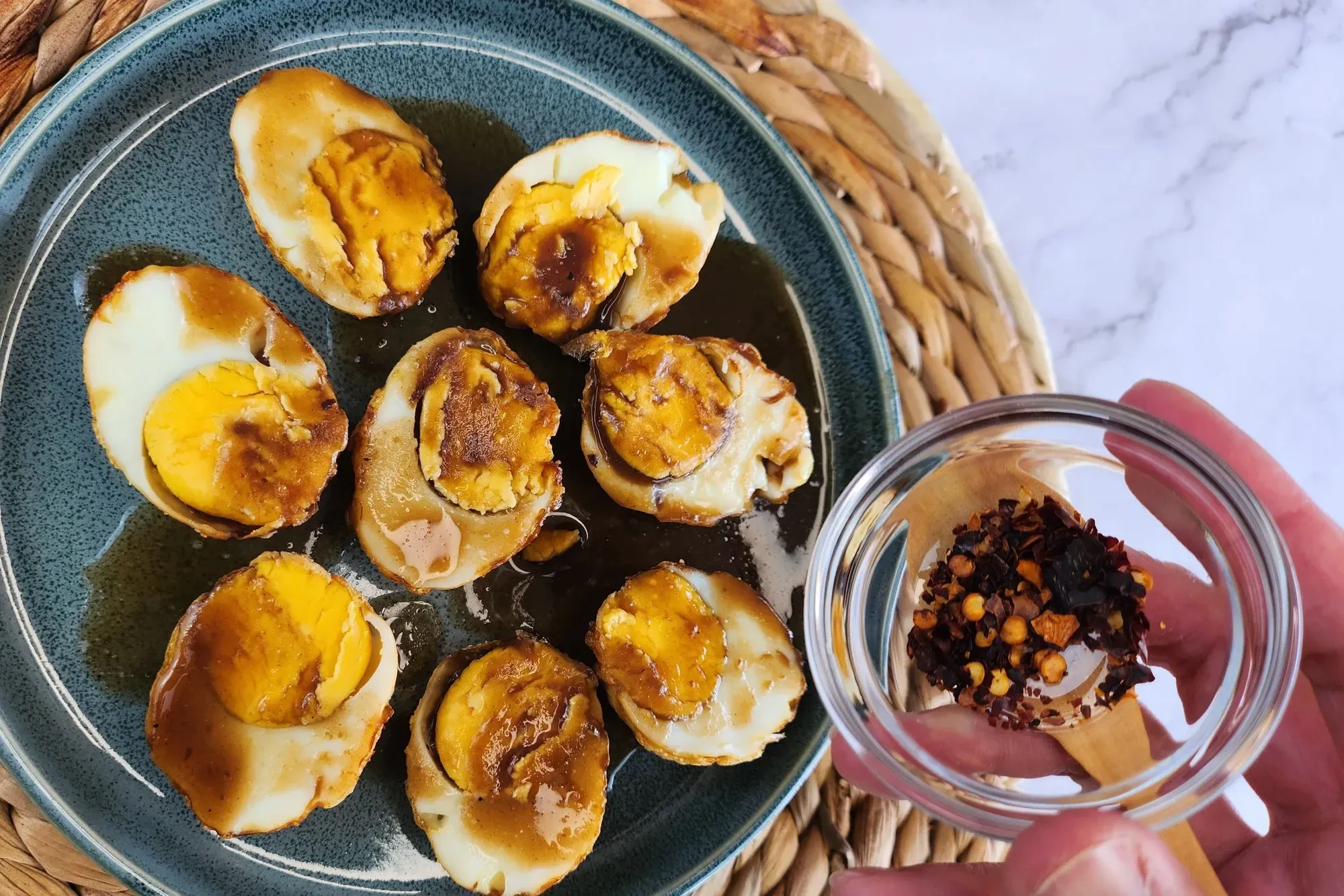 A bowl of chili flakes above the eggs.
