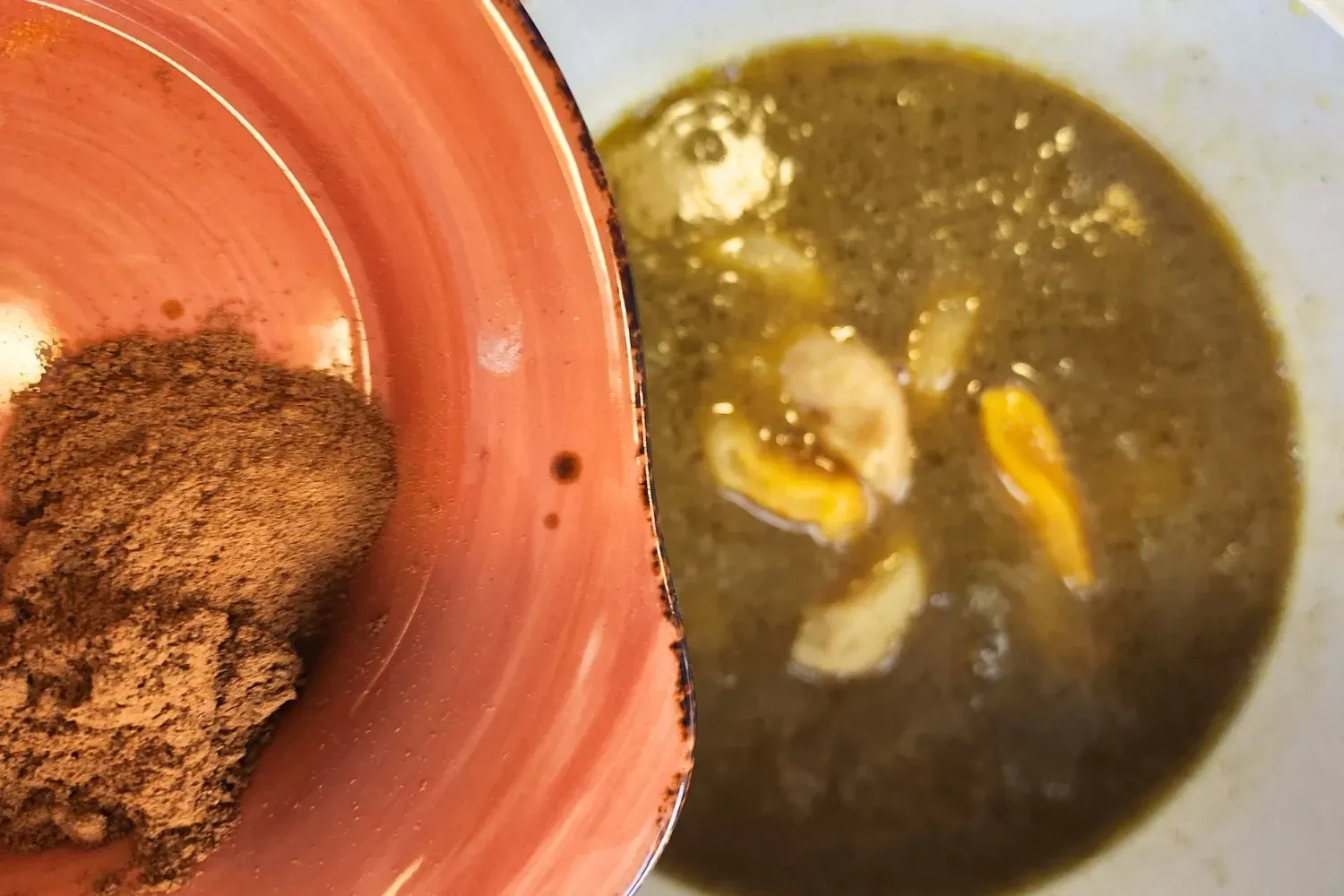 A bowl of cinnamon powder above a pot with broth.