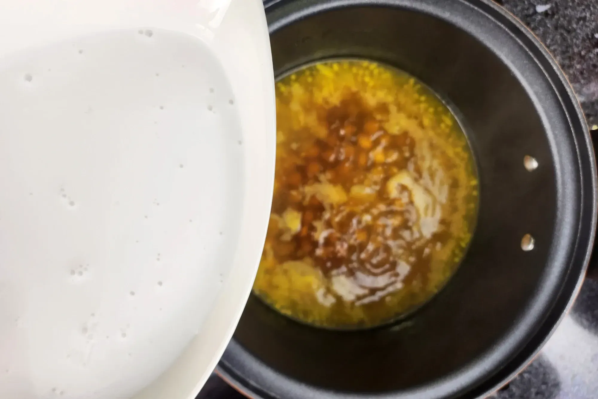 A yellow soup with chickpeas in a pot