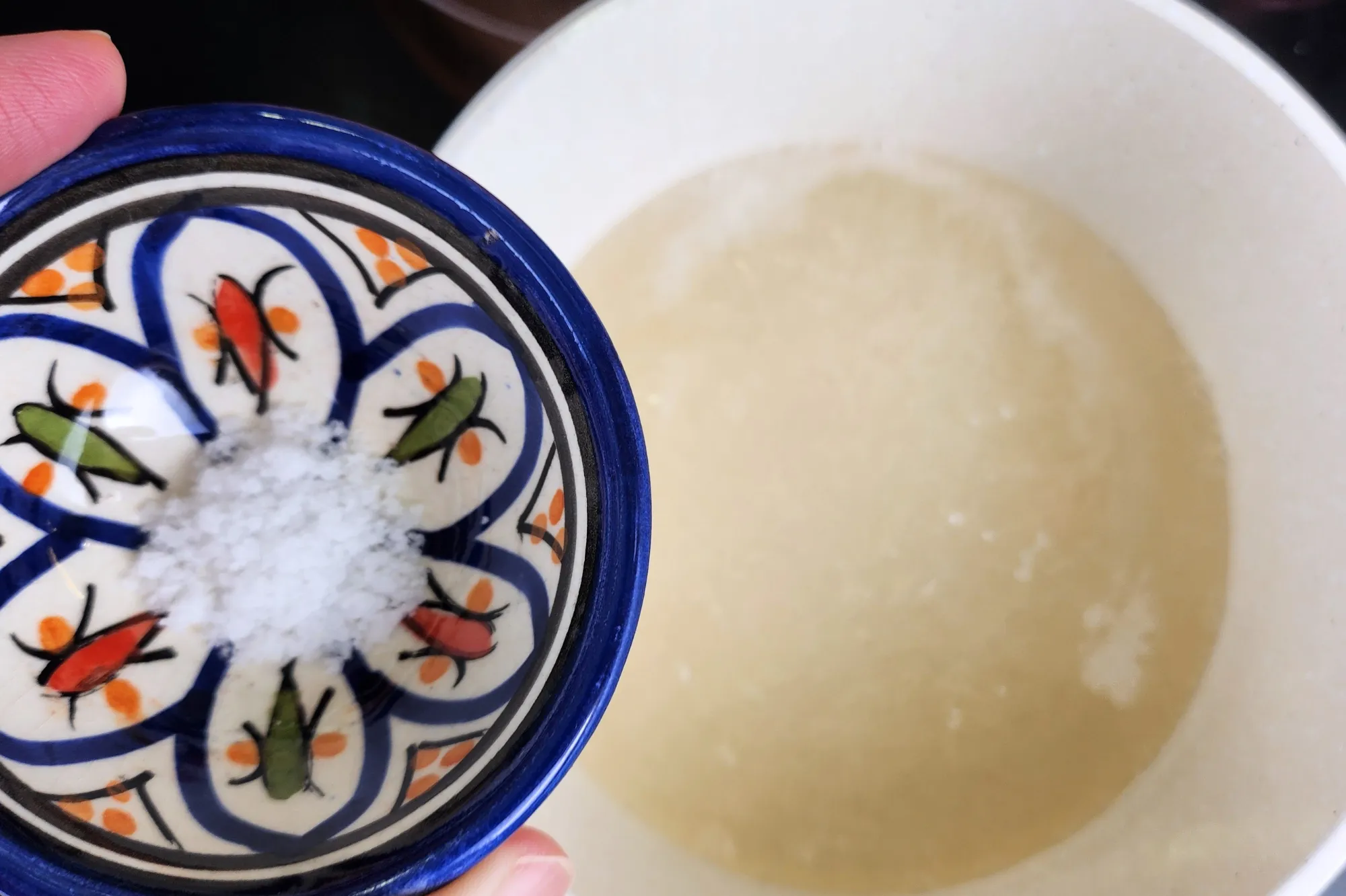 A bowl of salt above a pot