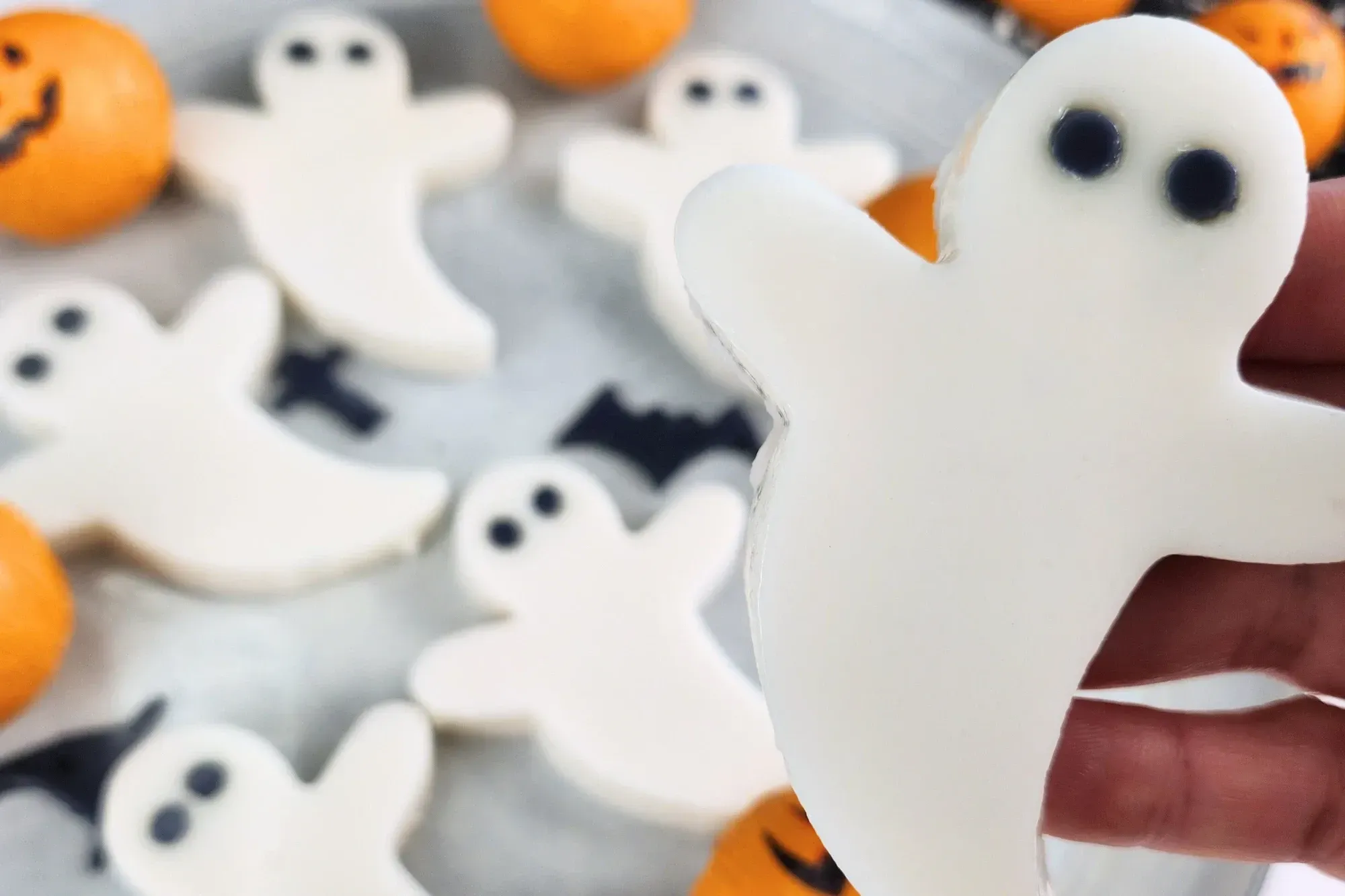 A hand is holding a ghost coconut jelly