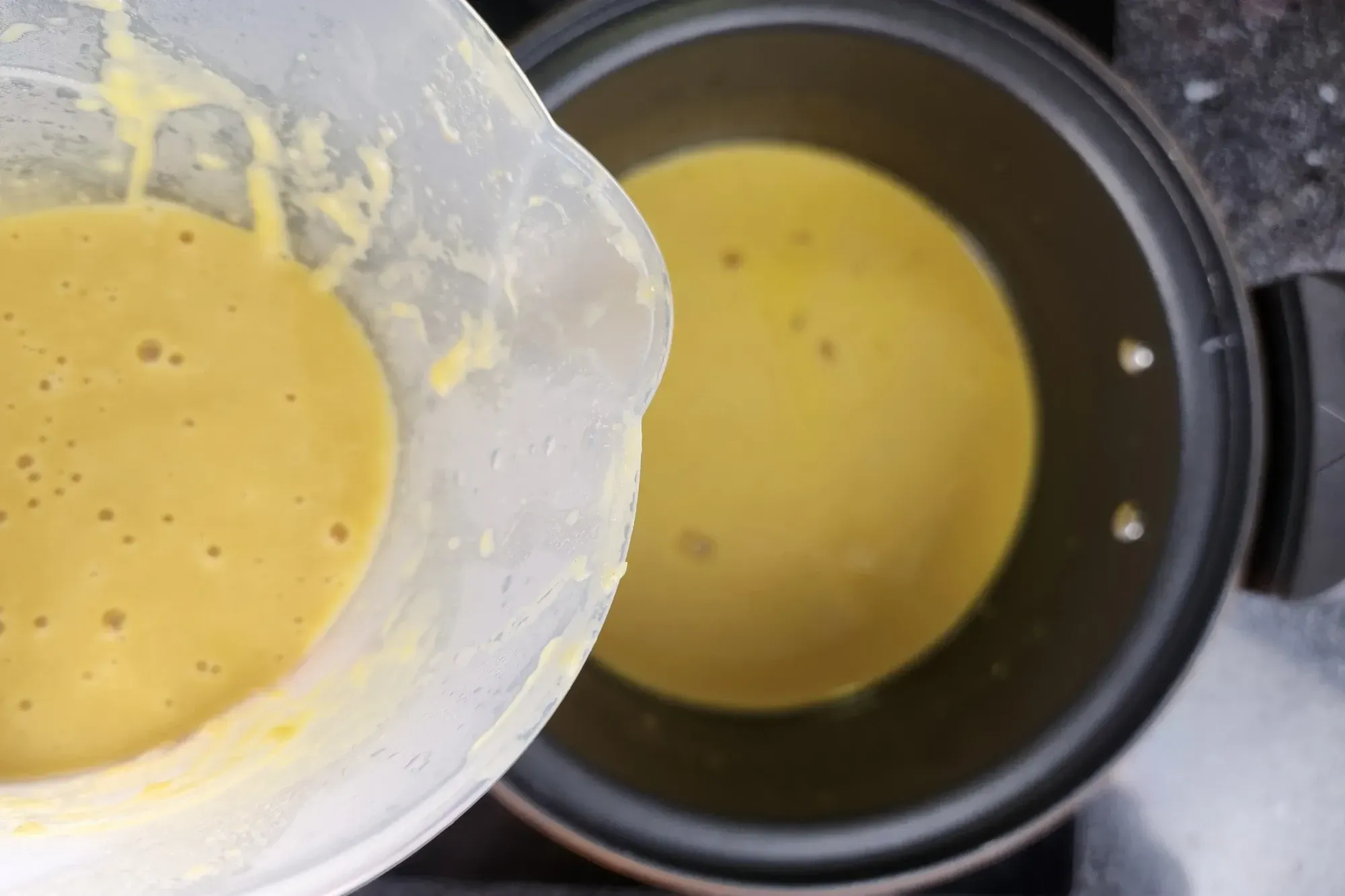 A jar of yellow cream above a pot