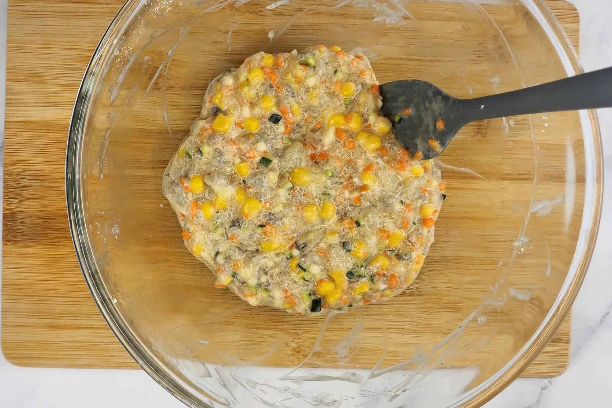 A mixed Shrimp Fritters in mixing bowl