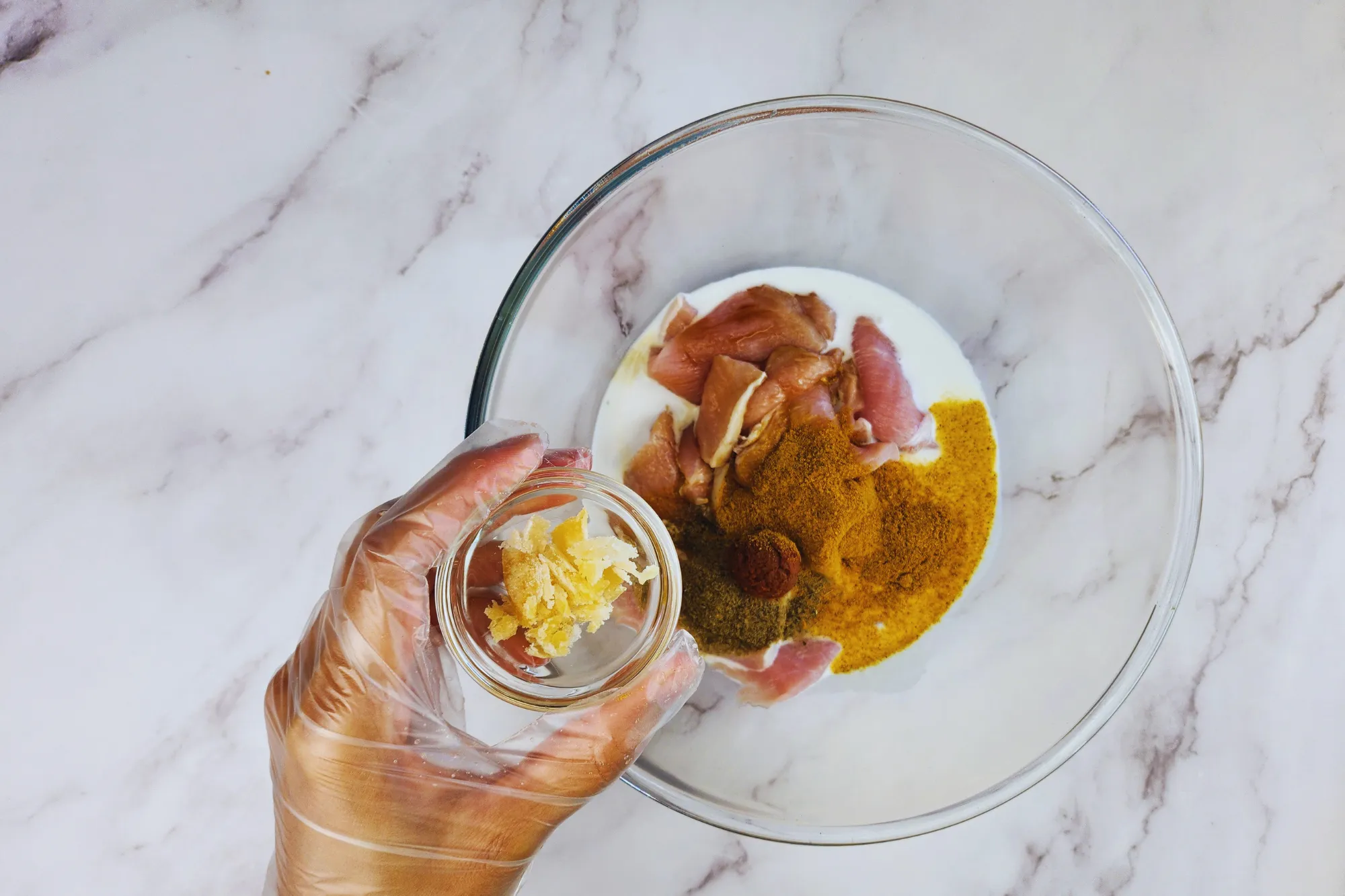 A mixing bowl and a hand holding of bowl of palm sugar