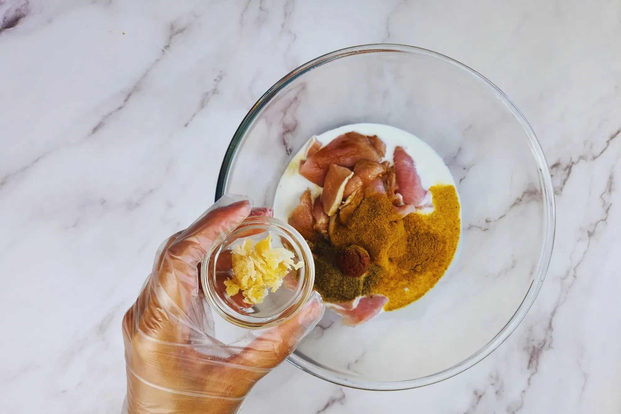 A mixing bowl and a hand holding of bowl of palm sugar