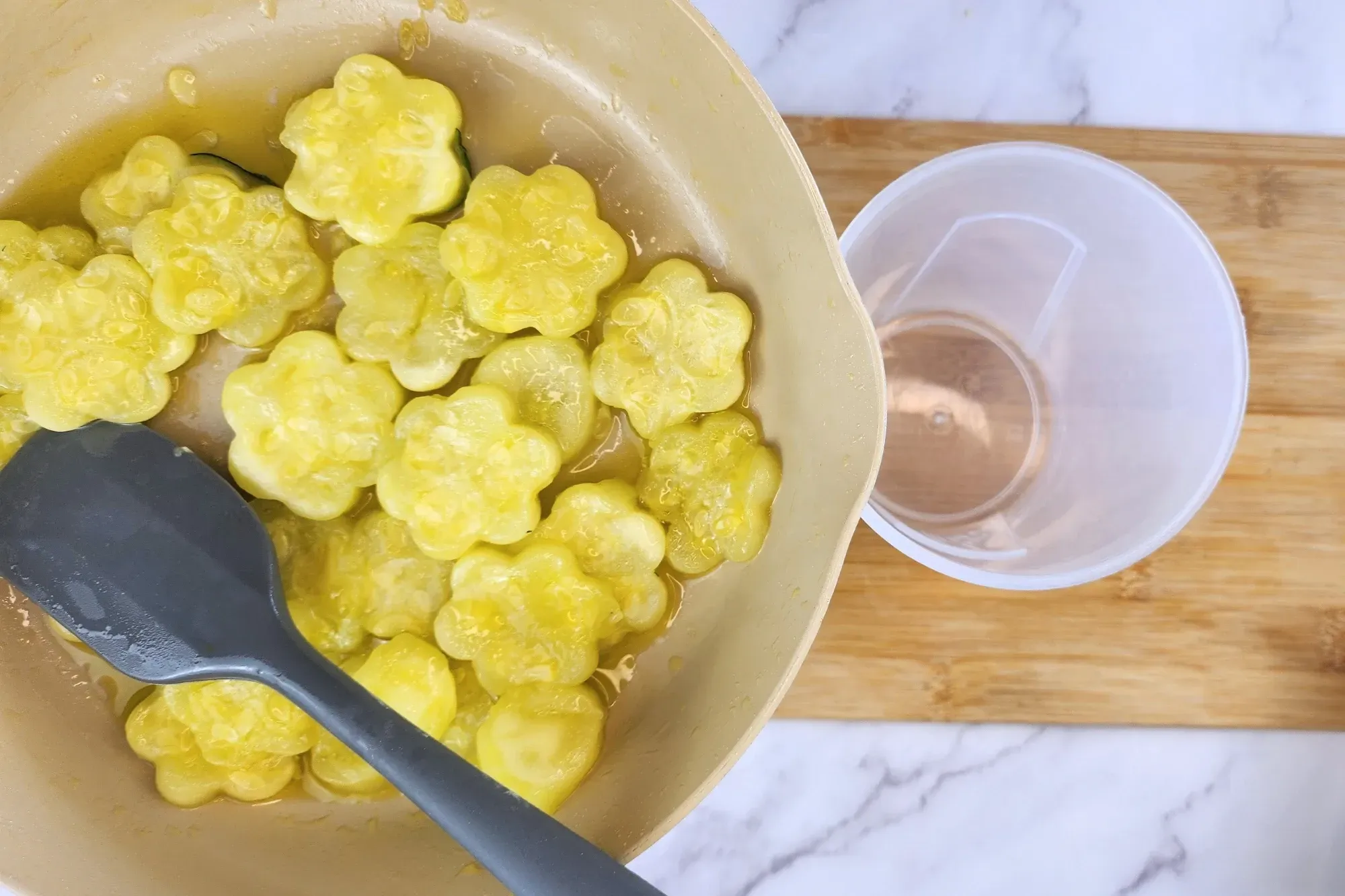 A pan of cooked center of zucchini is above a jar