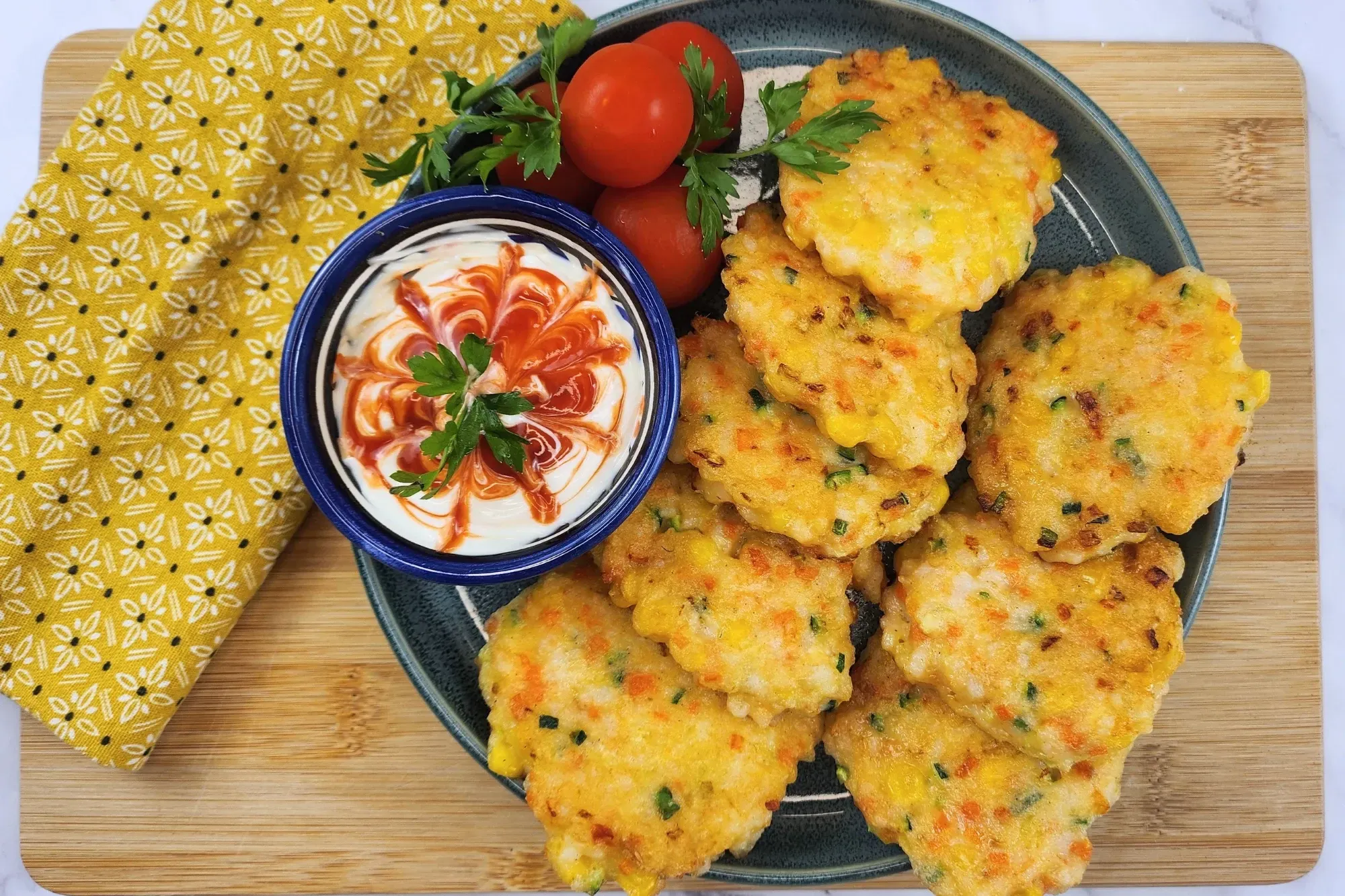 A plate of Shrimp Fritters with dipping sauce