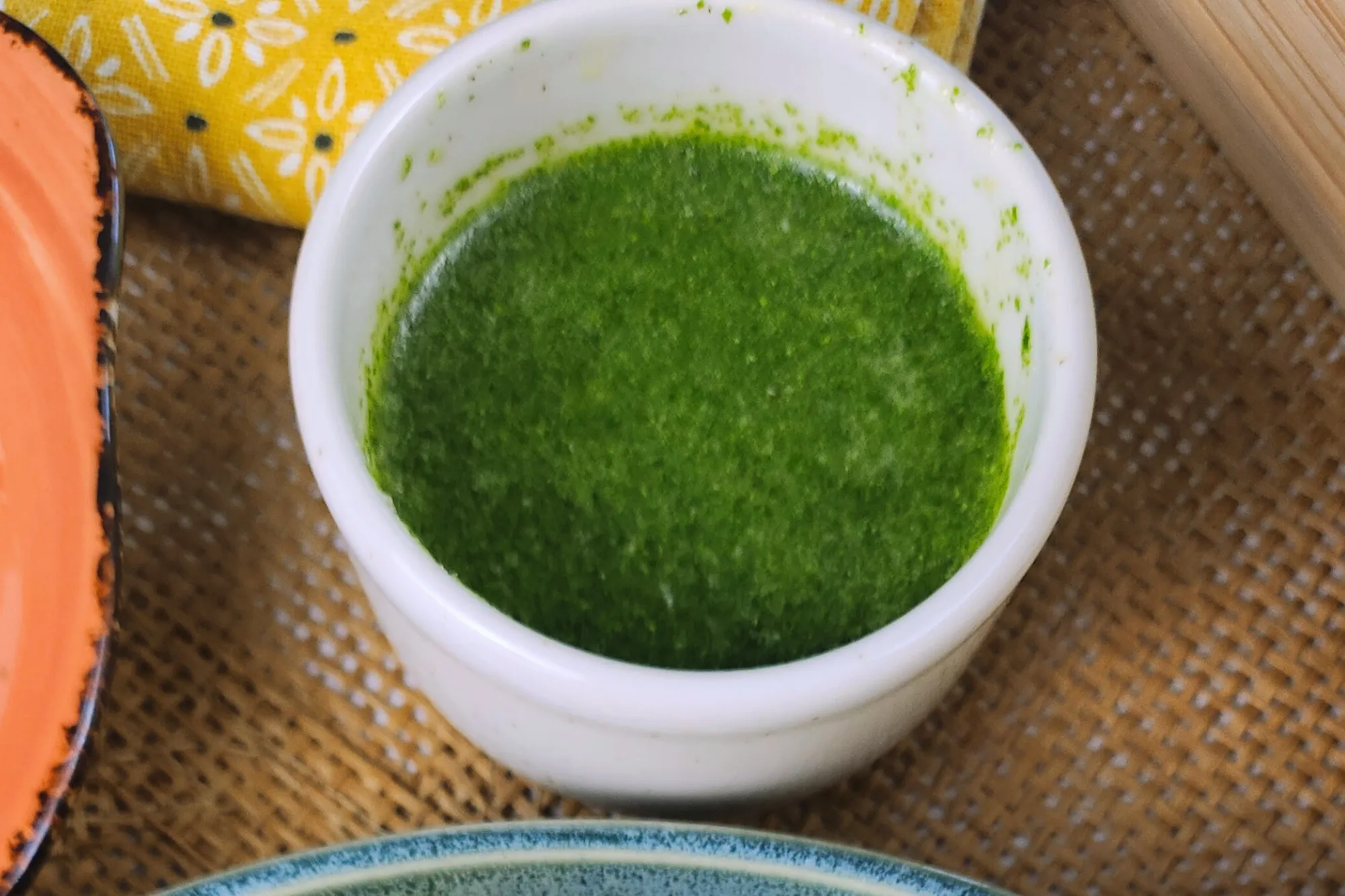 A small bowl of green sauce.