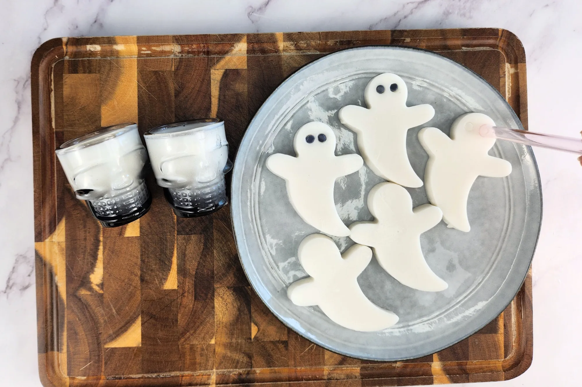 A straw pressed on a piece of white ghost jelly