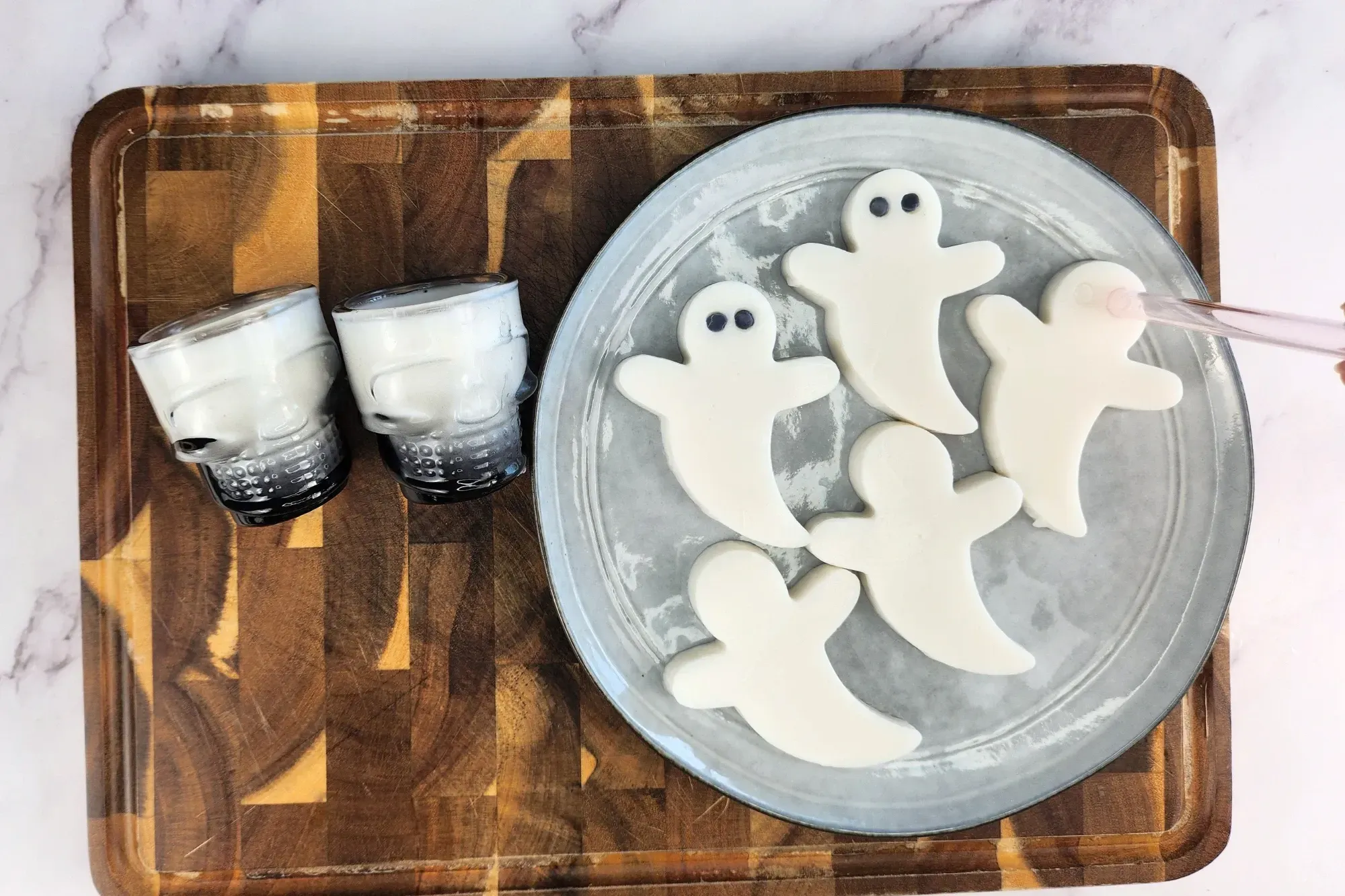 A straw pressed on a piece of white ghost jelly