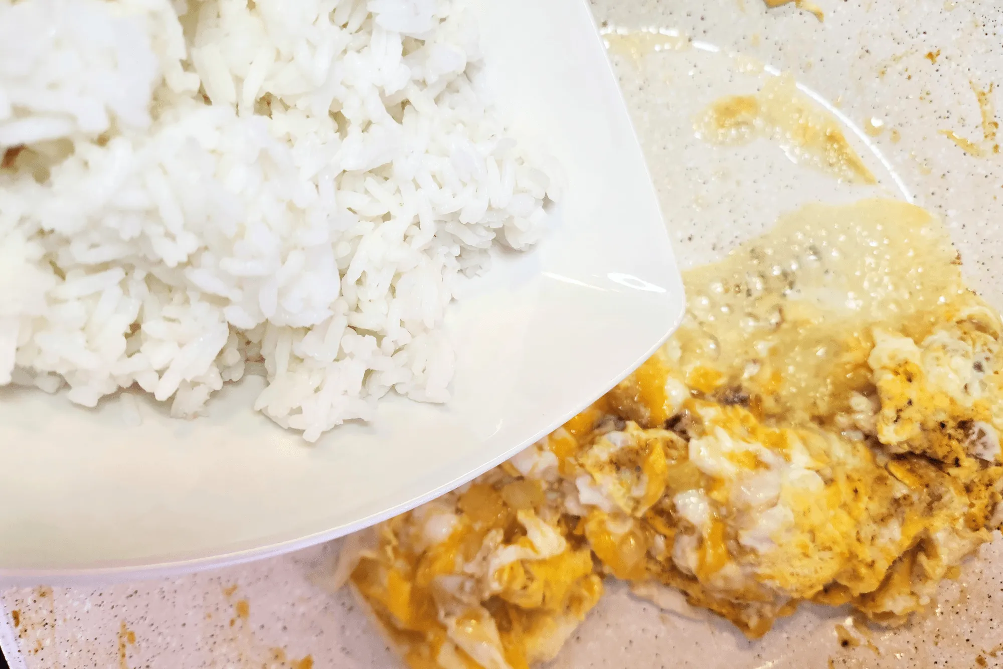 Add cooked rice to the pan, breaking up any clumps with a spatula.