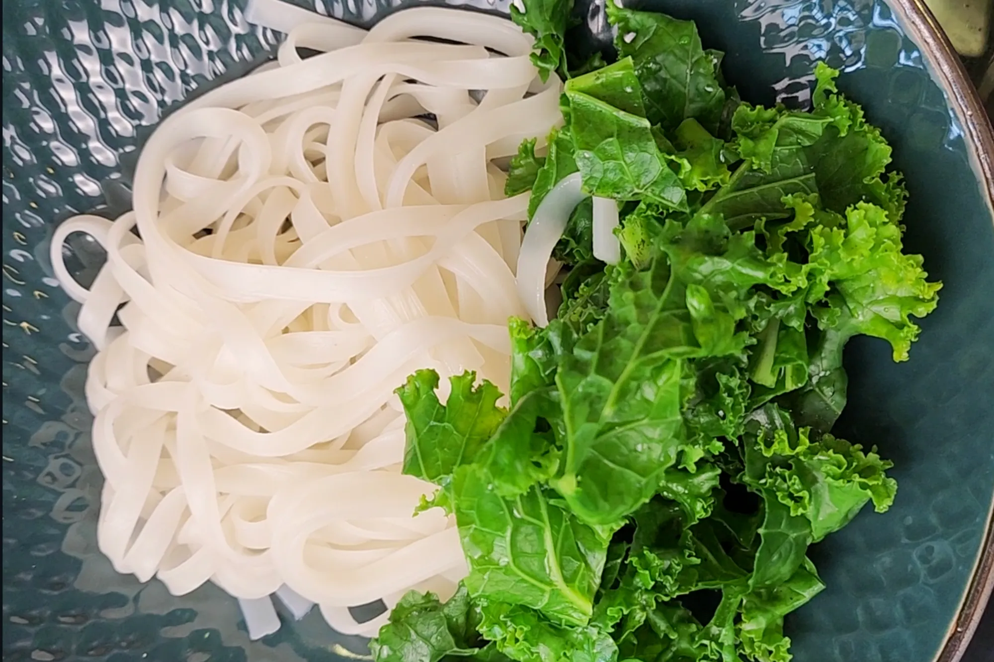 Add noodles and veggies to bowls