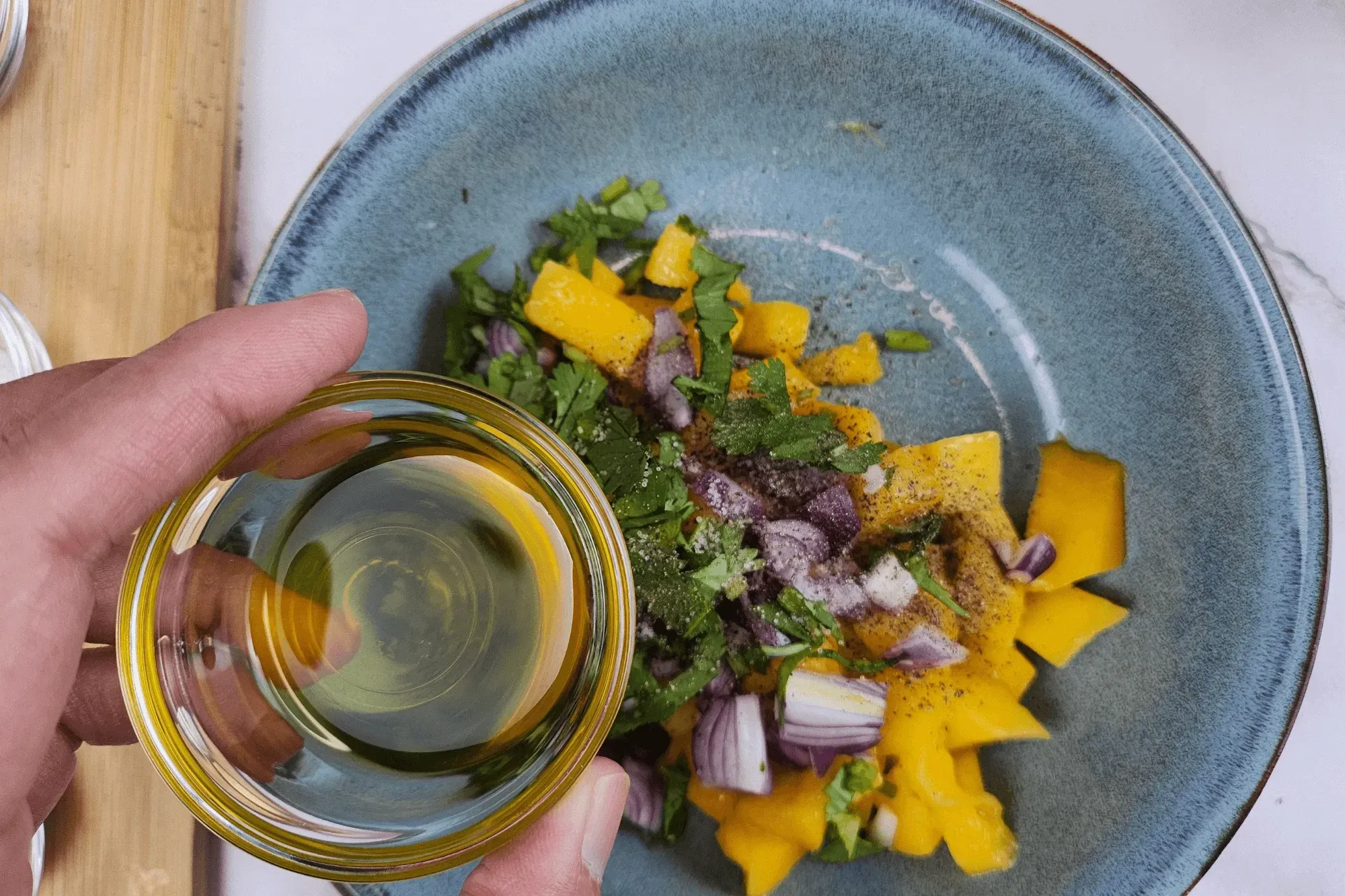Add olive oil  into mango salad