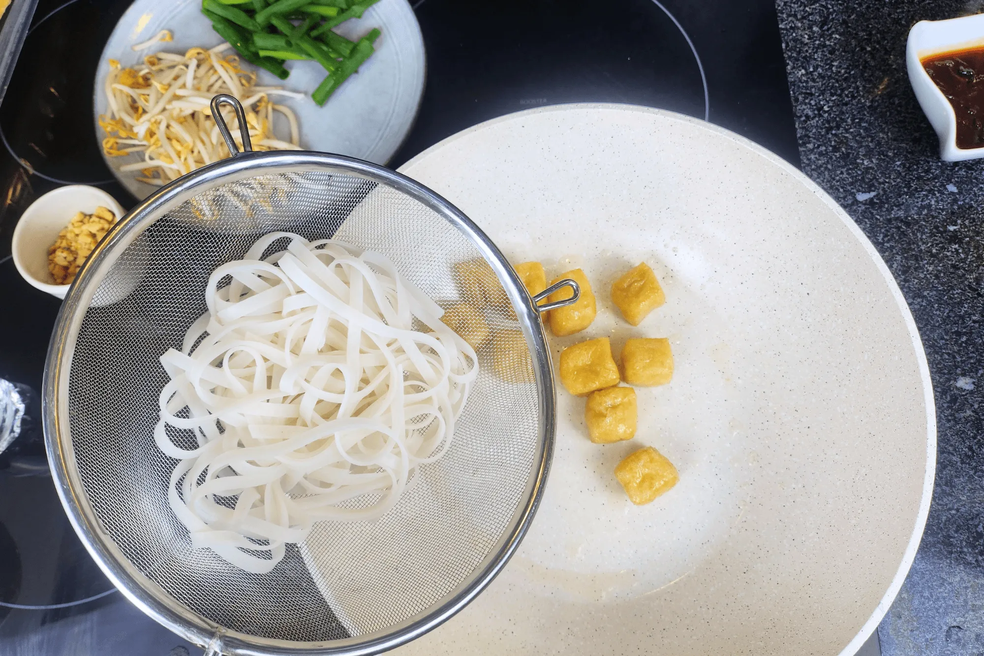 Add the boiled rice noodles into the pan