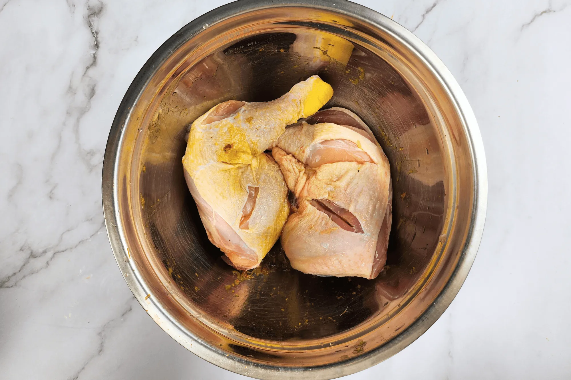 Add the chicken drumsticks with thigh to the bowl, ensuring they are well coated with the marinade.