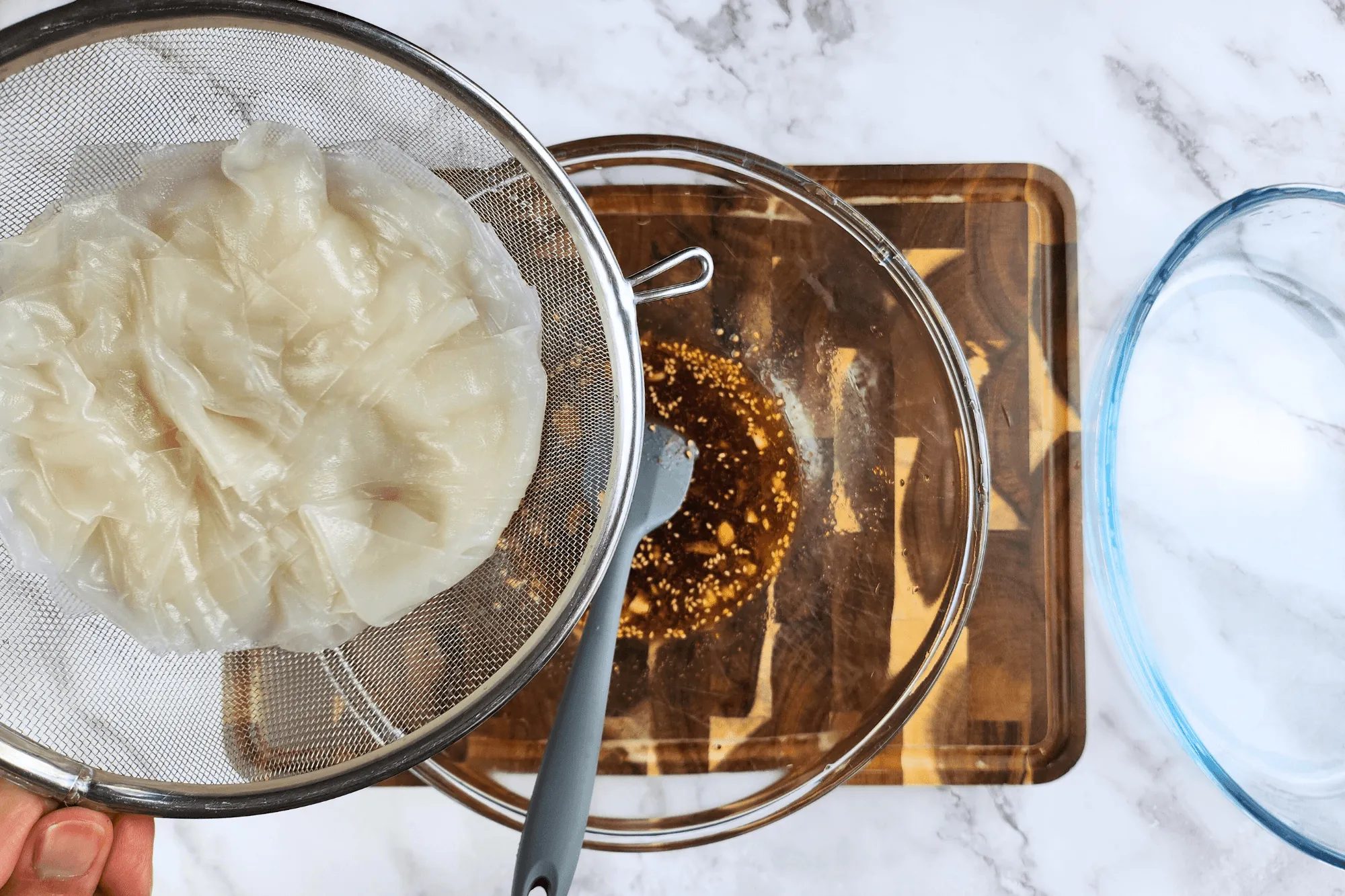 Add the soaked rice paper strips into the dressing sauce and mix it well.