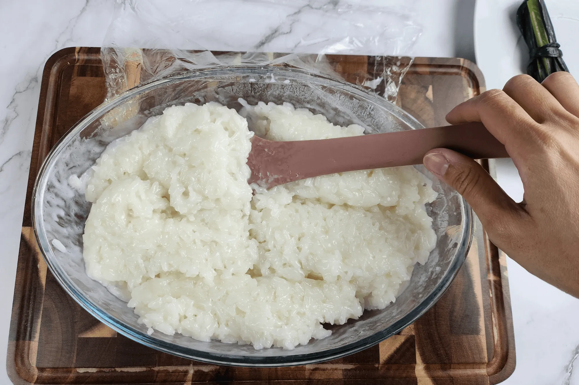 After the first 15 minutes, uncover and flip the sticky rice from top to bottom.