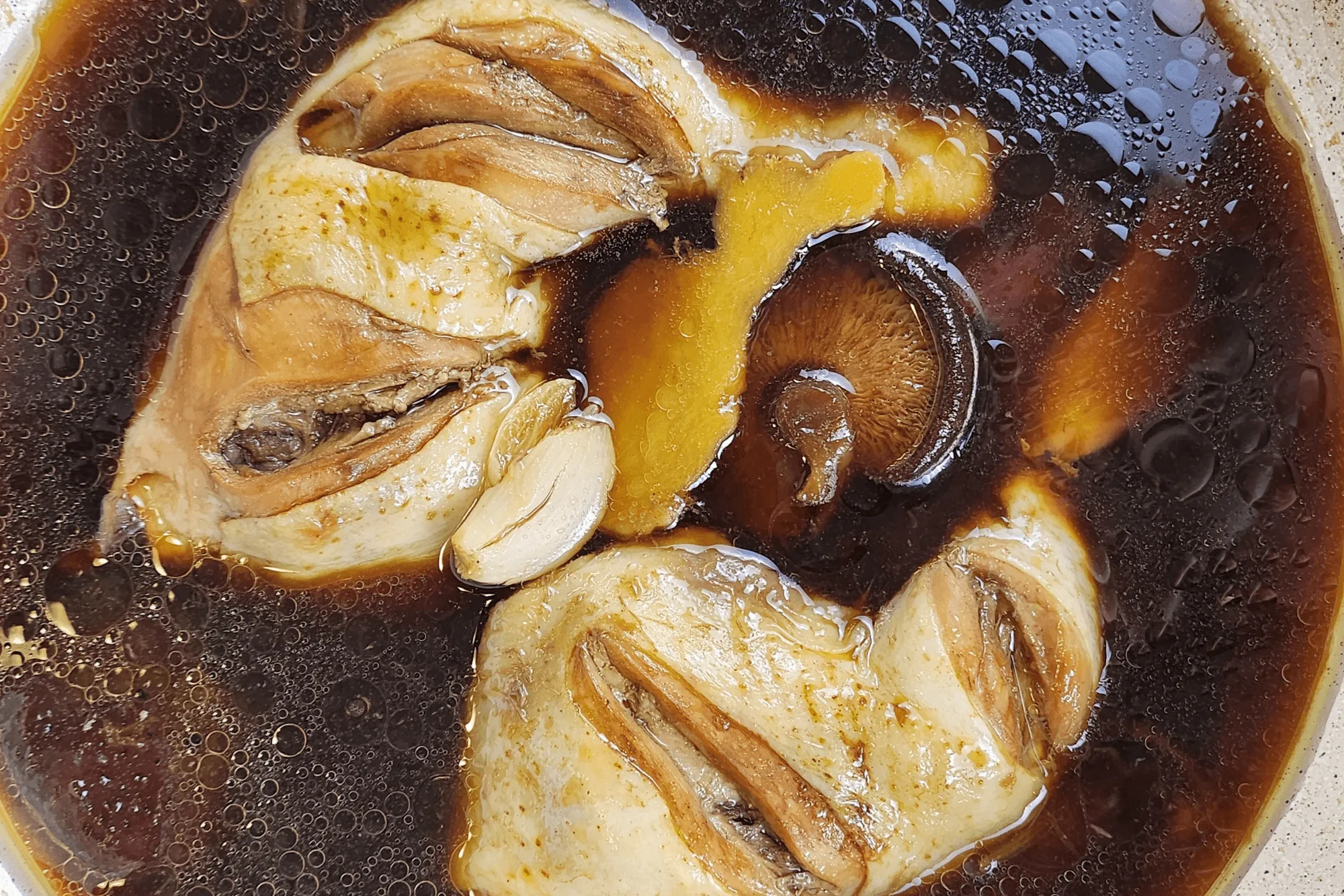 Cook over medium-low heat. While simmering, skim off any foam that rises to the surface. Simmer until the chicken becomes tender and develops a rich, brown color. Serve warm.