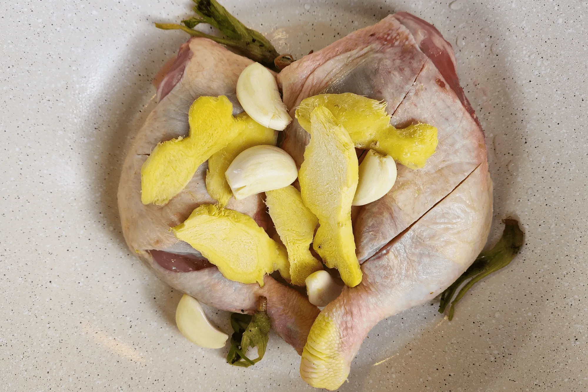 Crush the garlic, pepper, and coriander roots. Slice the ginger into thin pieces, then add everything into the pot.