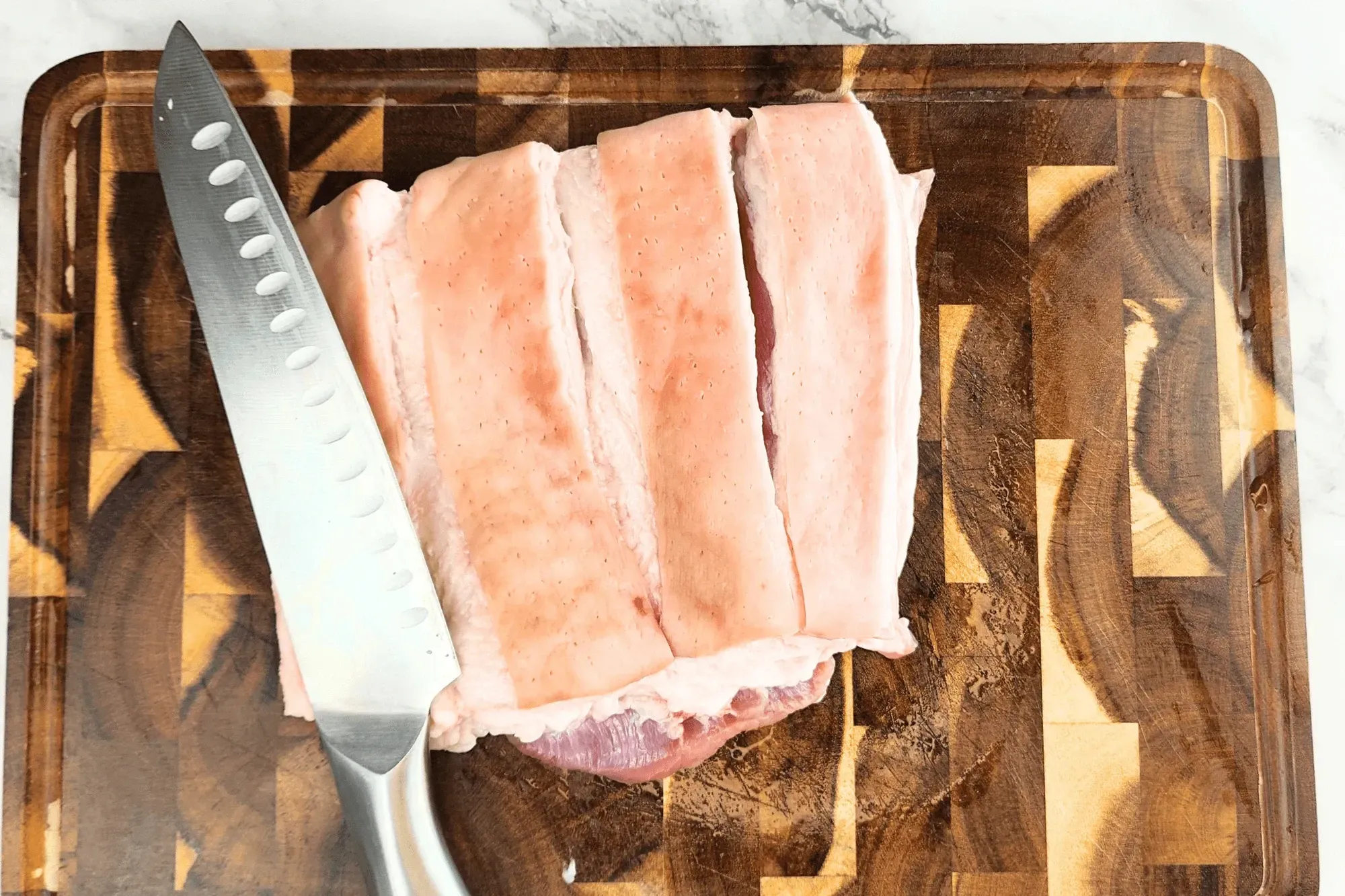 Cut into the skin, deep enough to reach the meat but not through it.