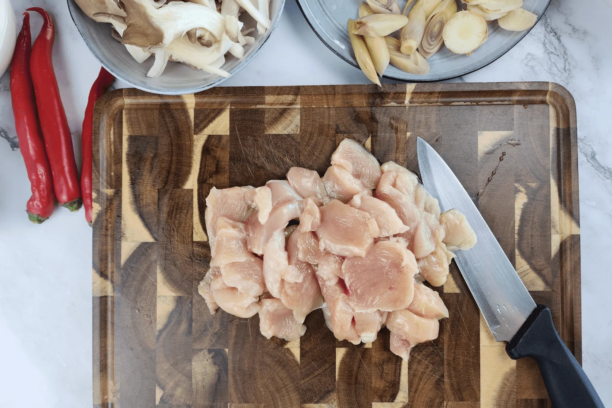 Cut the chicken into bite-sized pieces. If you don’t like chicken skin, you can remove it, or substitute with chicken breast if preferred.