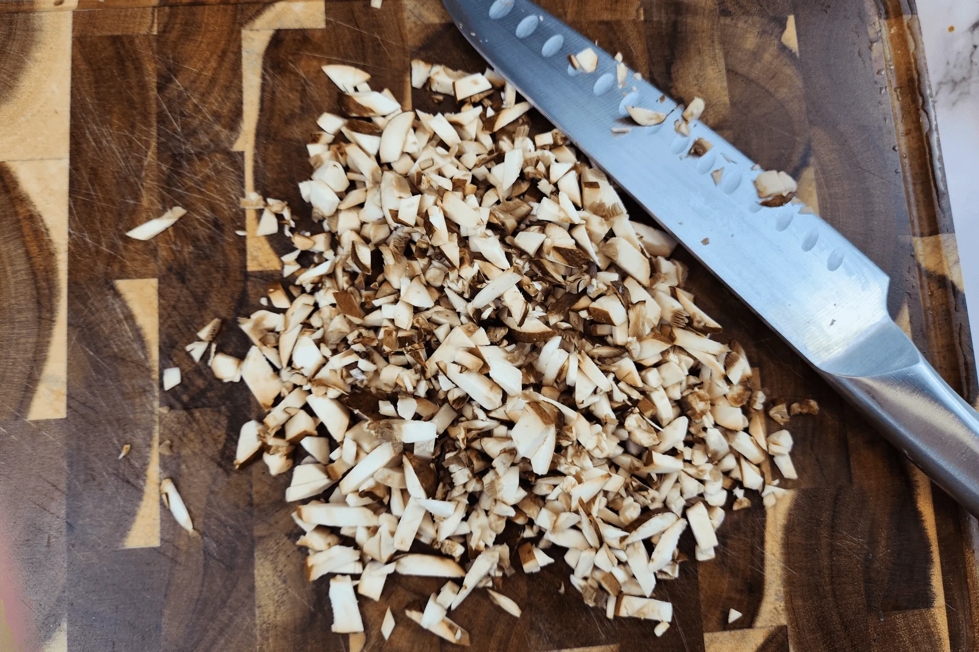  Finely mince mushroom to enhance their meaty and umami-rich texture.