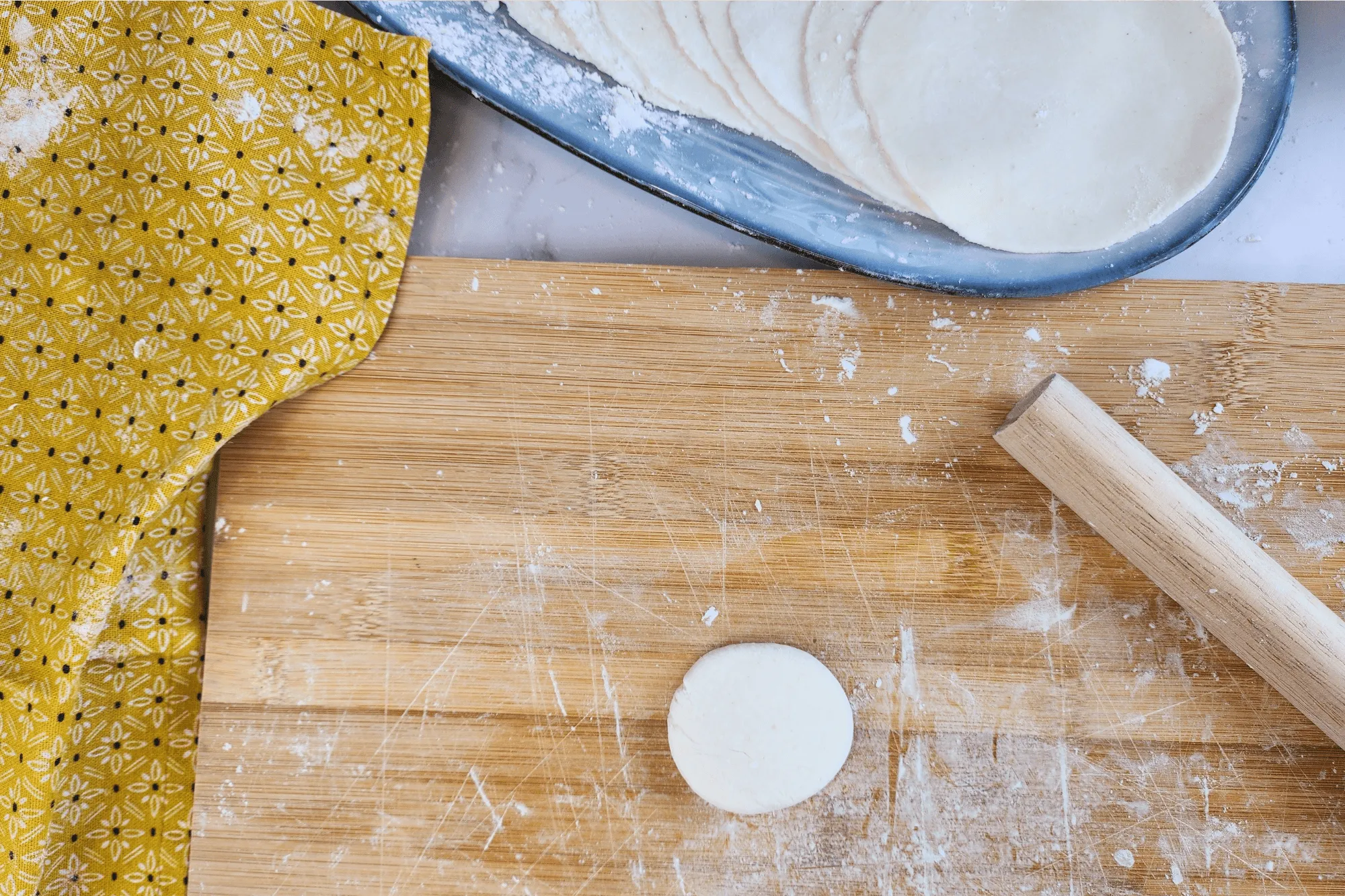 Gather any dough scraps, cover them with a damp towel, and re-roll them to make more wrappers!