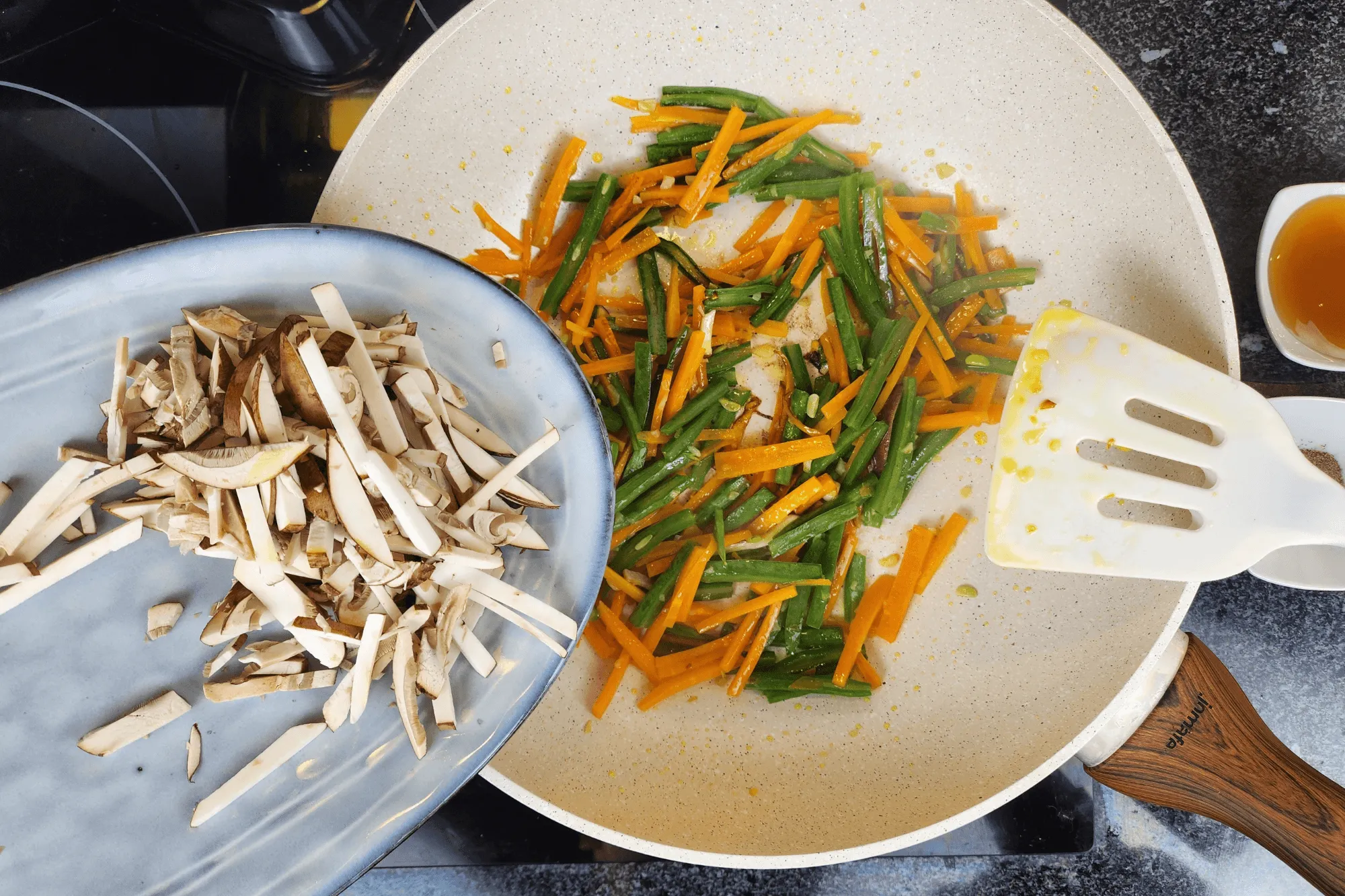 Heat a pan over medium heat, add oil, and once hot, sauté the galic until it fragants, then add the carrot, snow peas, and shiitake mushrooms until well combined.