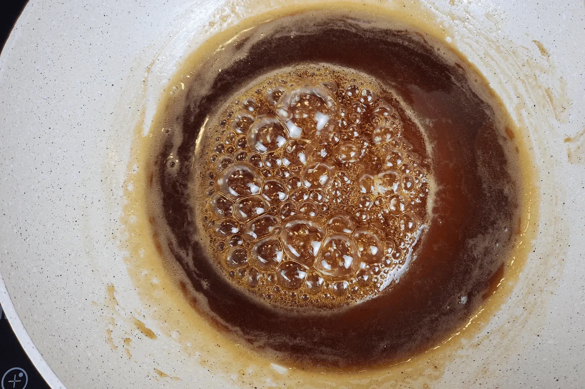 Heat a pan over medium heat. Add water, palm sugar, and brown sugar, stirring well.