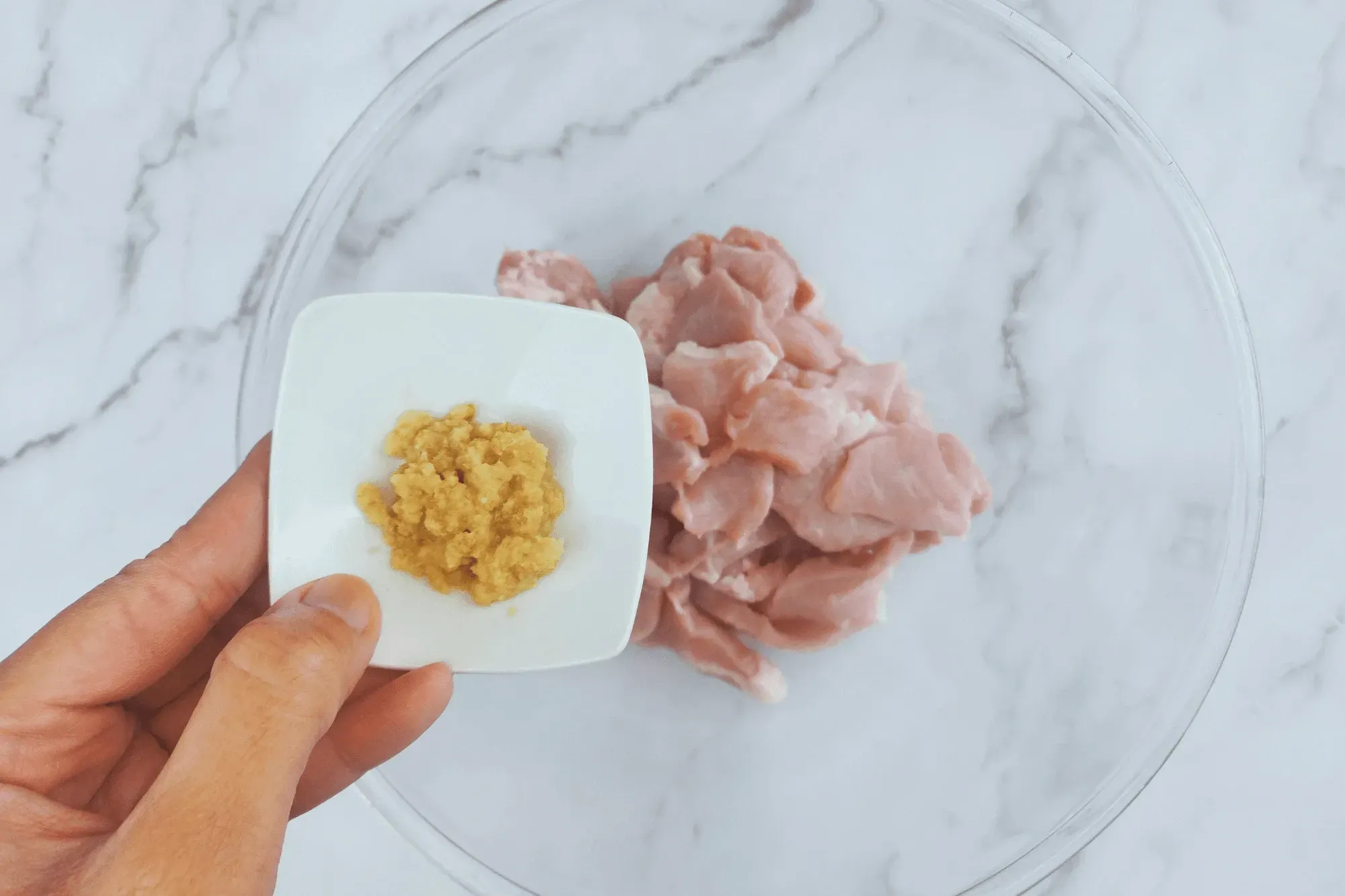 In a bowl, add sliced pork mix with grated ginger