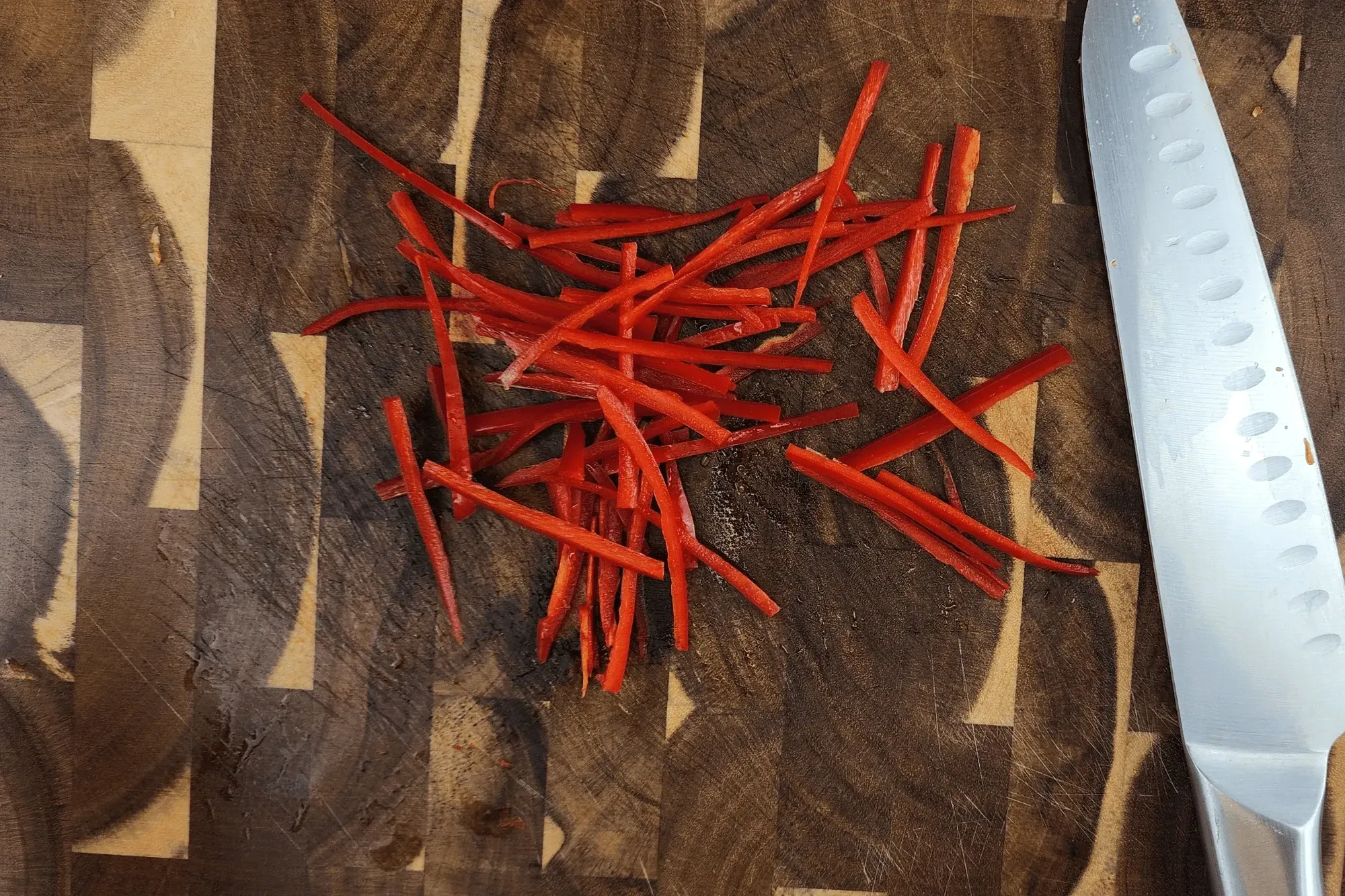 Julienne the chili peppers into thin, 2-inch-long strips. 