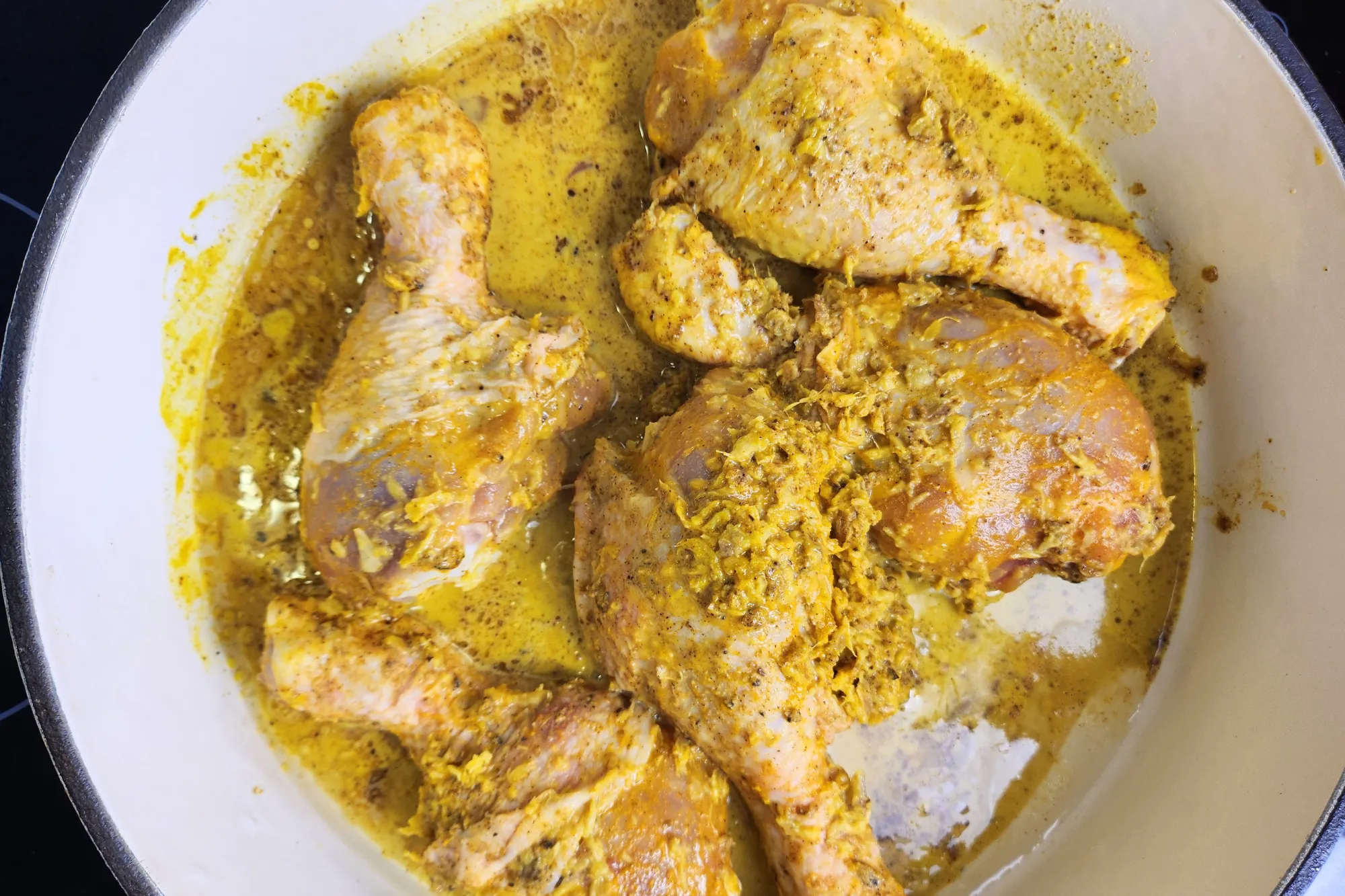 Marinated chickens is in a pan. 