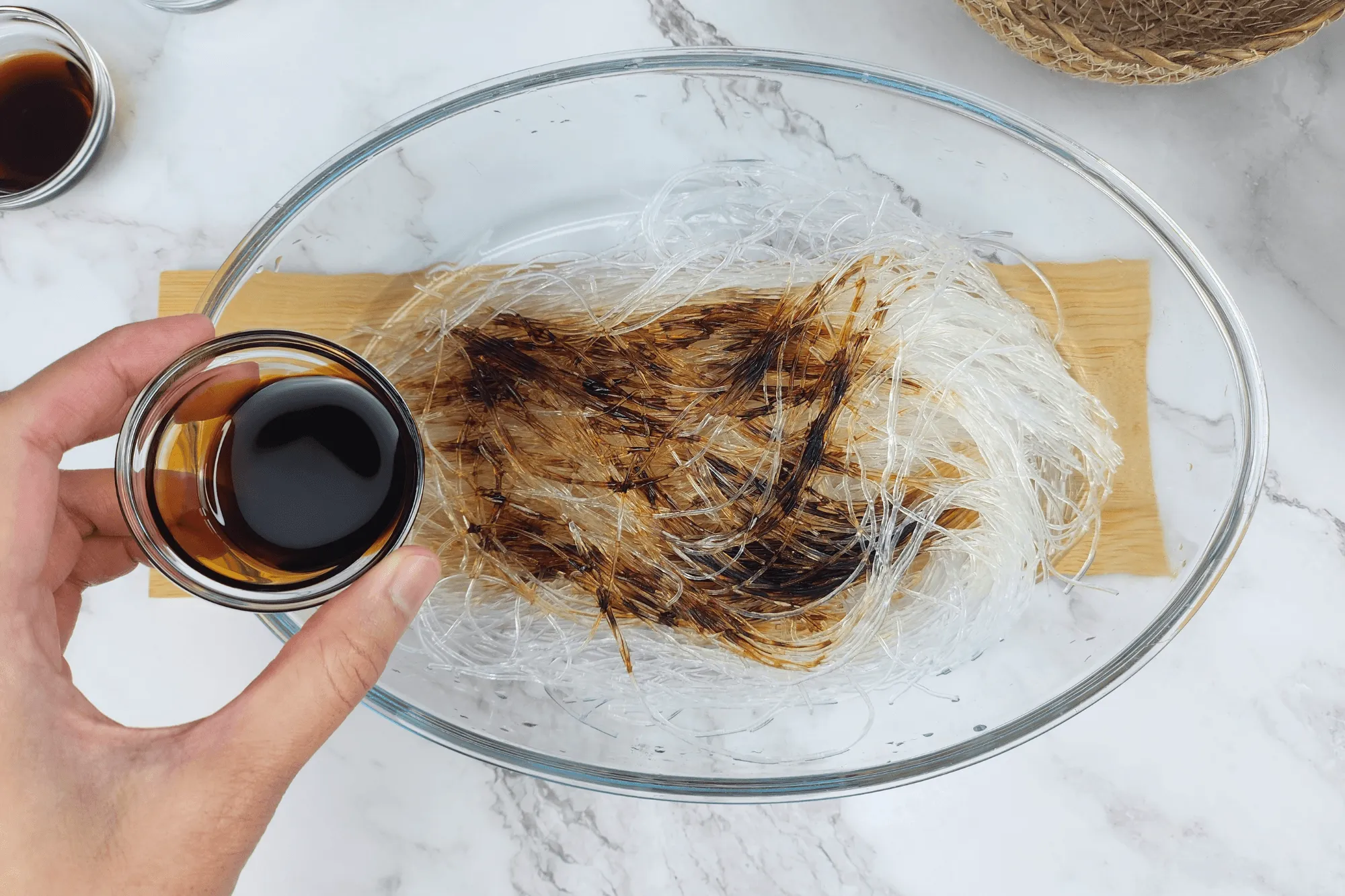  mix the softened glass noodles with dark soy sauce to give them a deeper color.