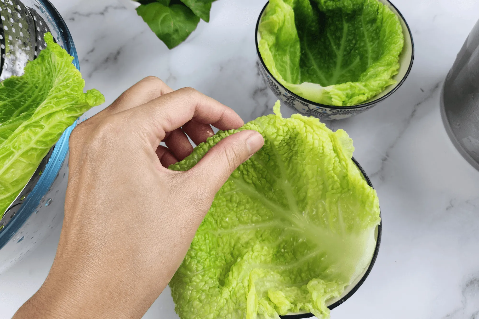 mold and line it with a cabbage leaf, folding the edges down to match the container's rim.