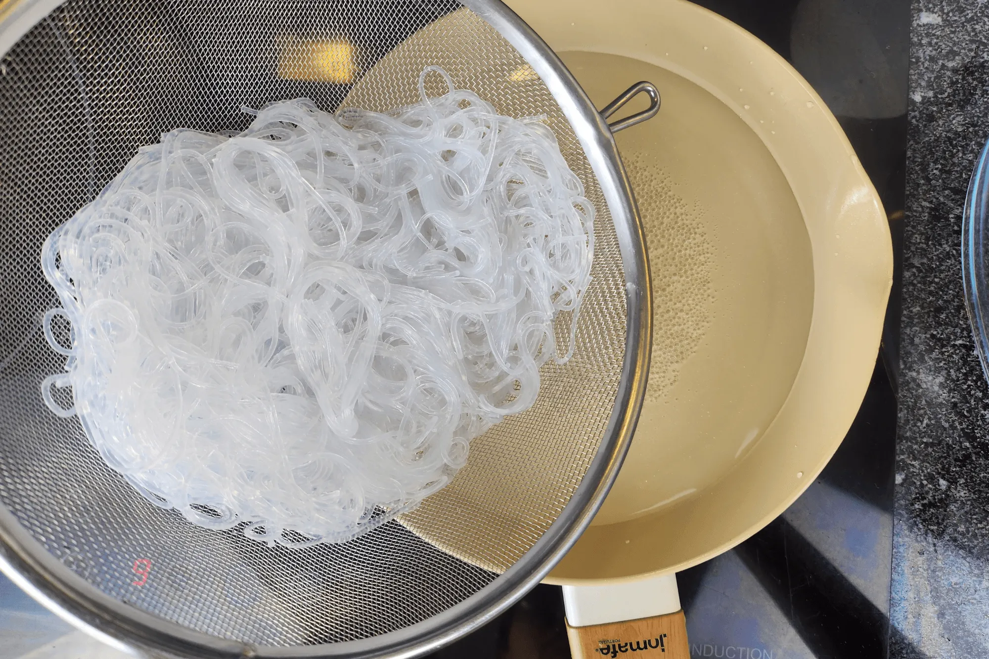 Once boiling, add the soaked glass noodles and cook for about 1 minute