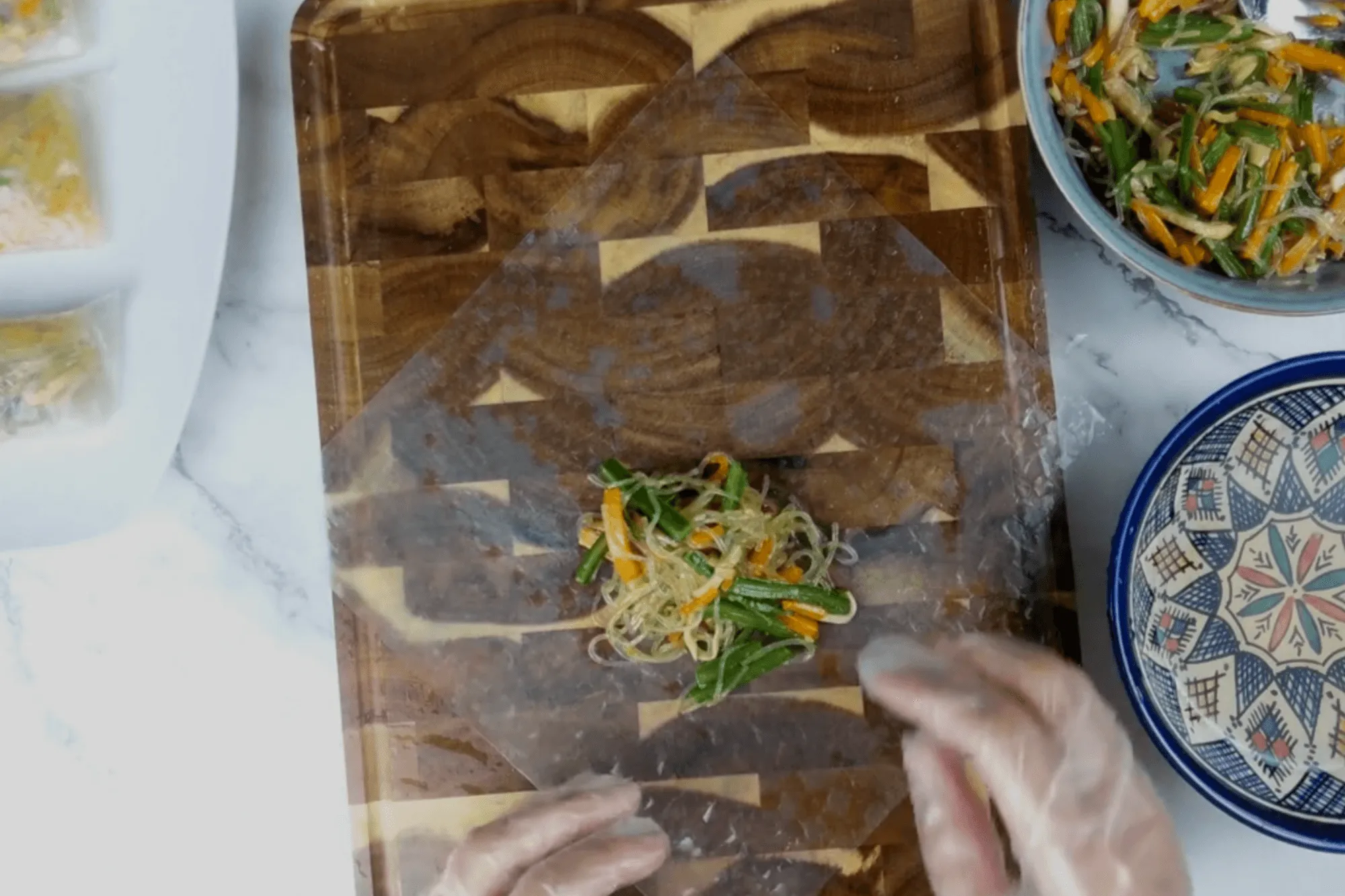 Place a sheet of rice paper on a flat surface and brush both sides with the vinegar solution until it softens.