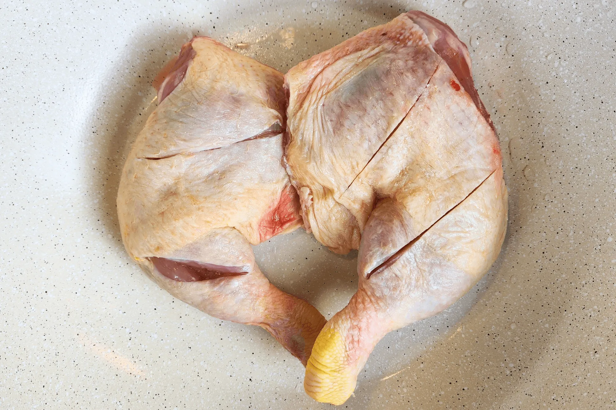 Place the chicken thighs with drumsticks attached in a pot without turning on the heat yet.