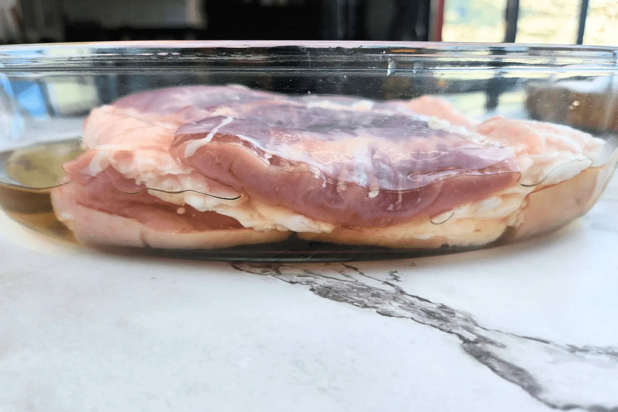Place the pork belly skin-side down in a bowl with vinegar and let it soak for 15-20 minutes. 