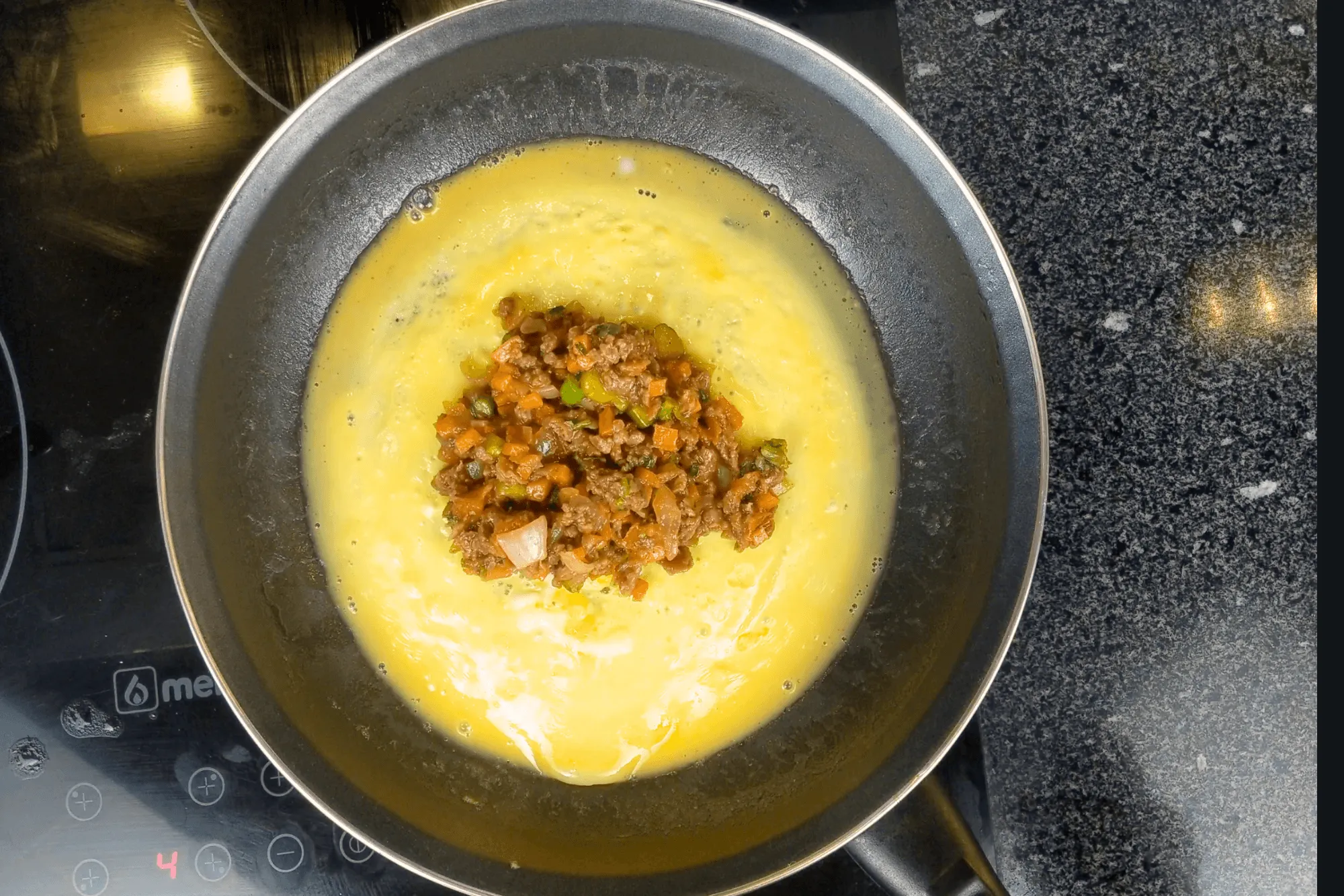 Place the prepared filling mixture in the center of the omelette.