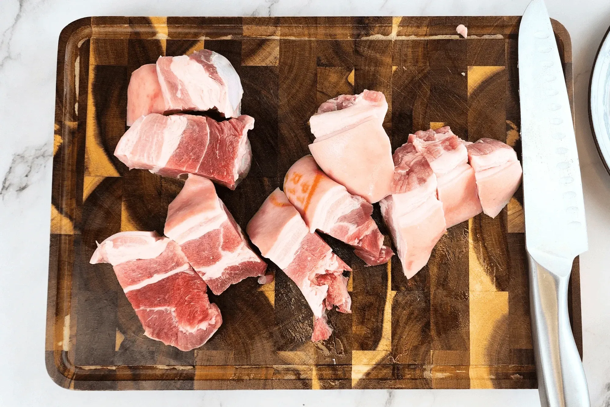 pork belly pieces on chopping board