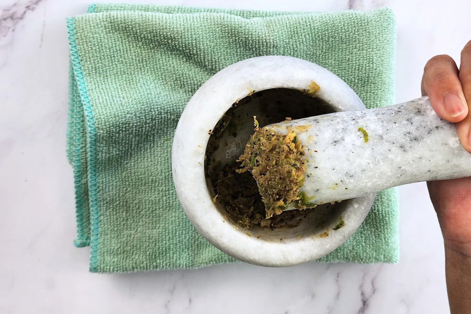 Pound cilantro roots, garlic, and black pepper into a paste