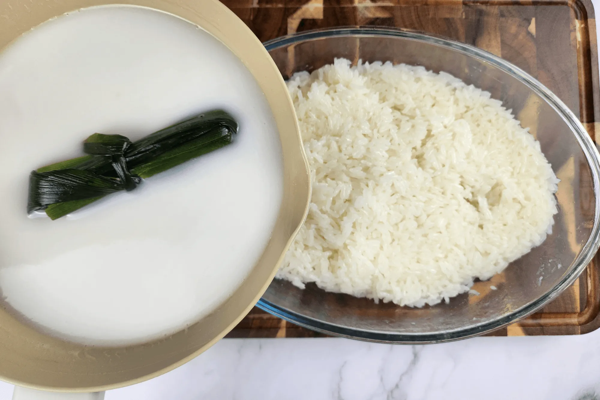 Pour the seasoned coconut milk over the warm steamed sticky rice