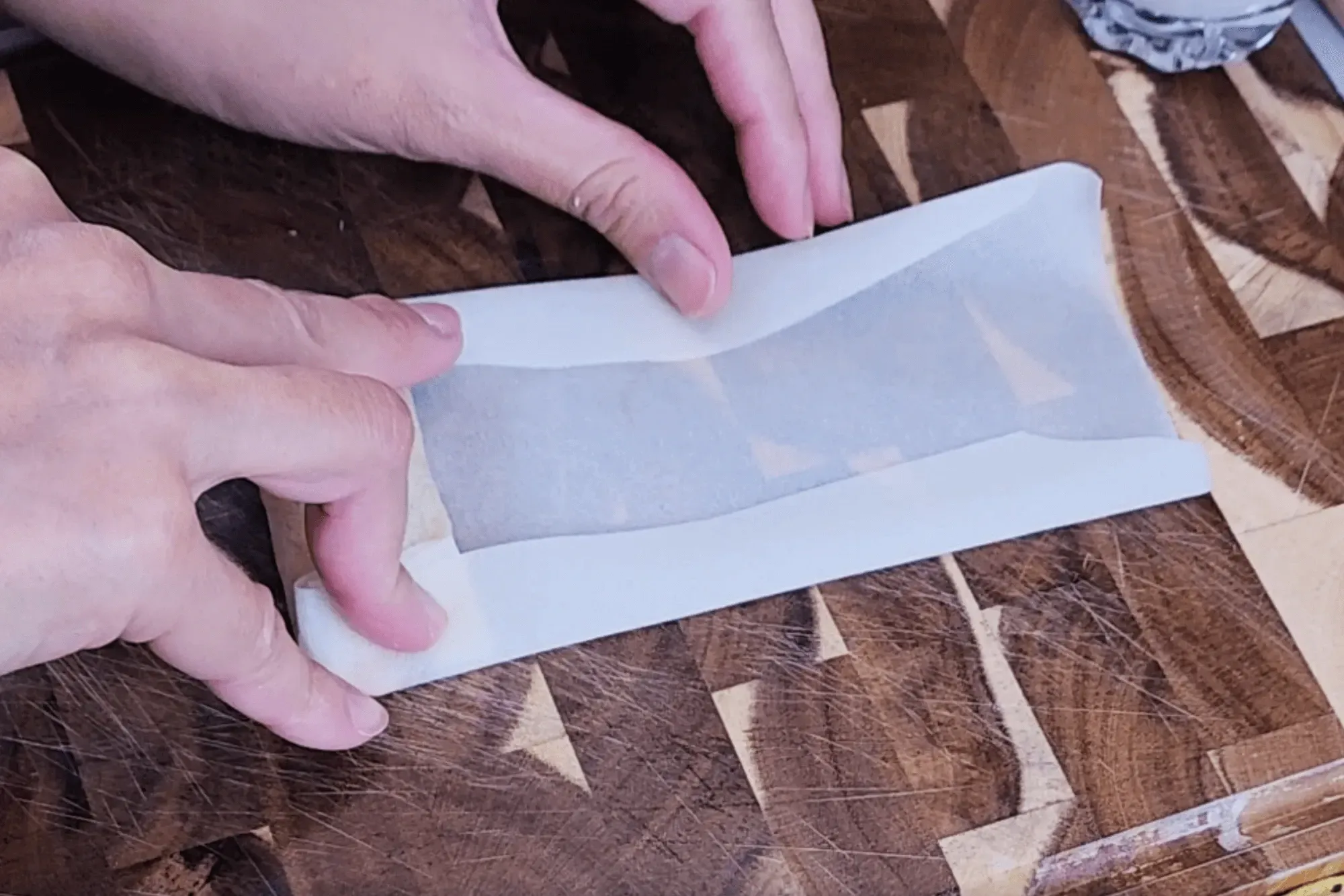 Rolling it over, then fold in both sides.