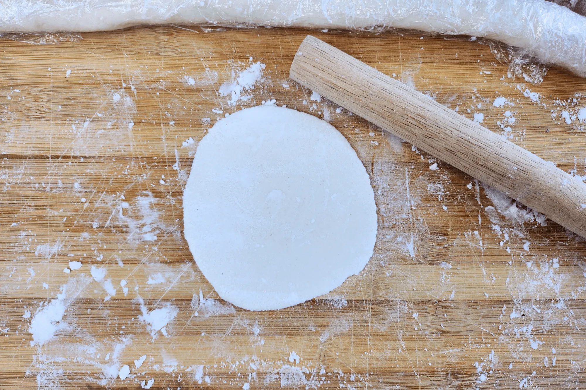 Rotate the dough 90 degrees and roll again, trying to form a thin circle.