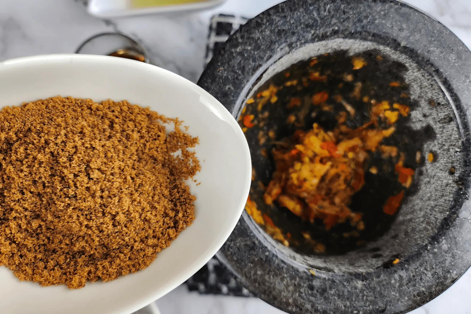 Season with coconut sugar, fish sauce, lime juice, and 2 tablespoons of the chicken broth from the cooking pot.