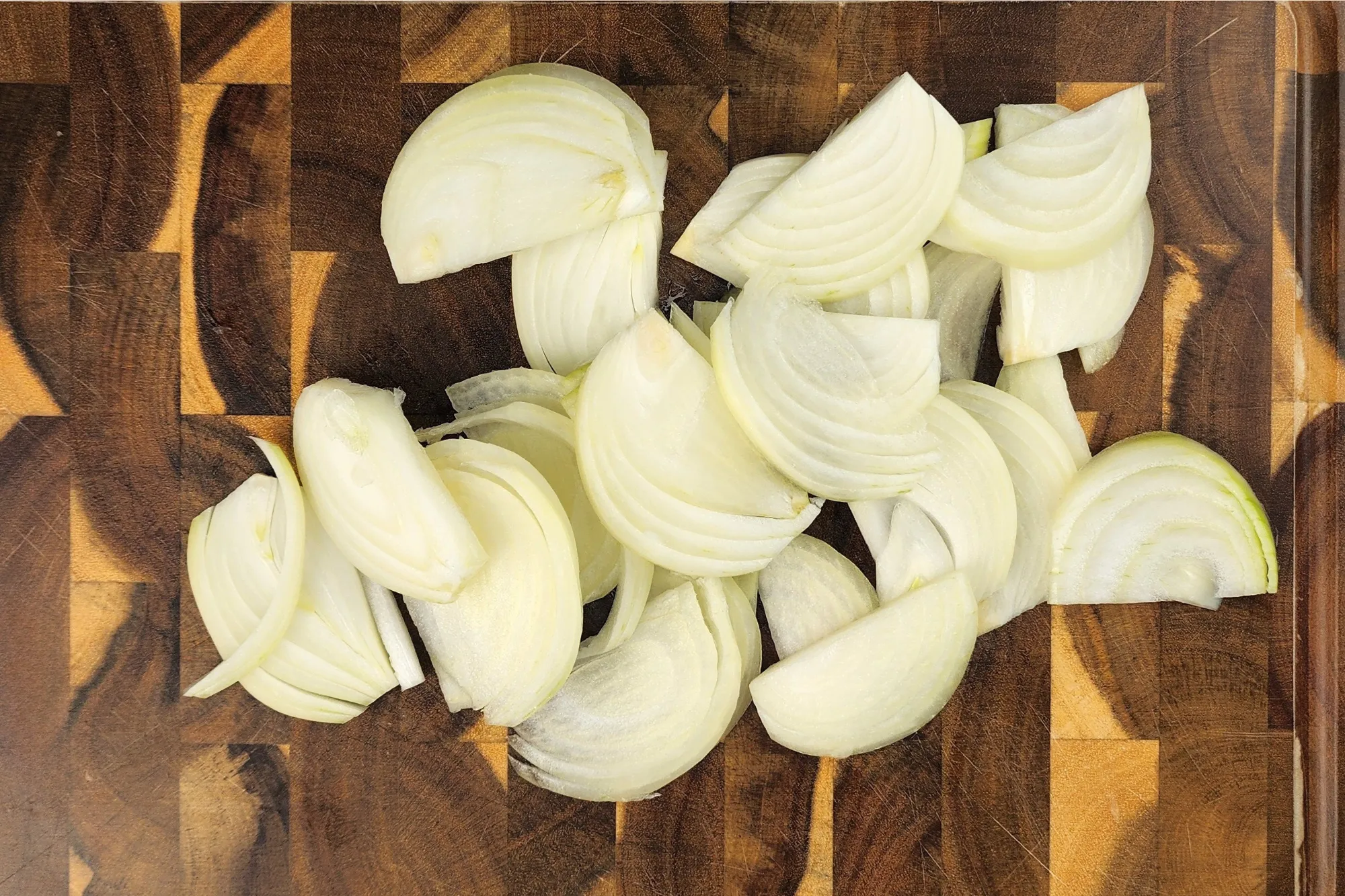 Sliced onion on a wooden board.